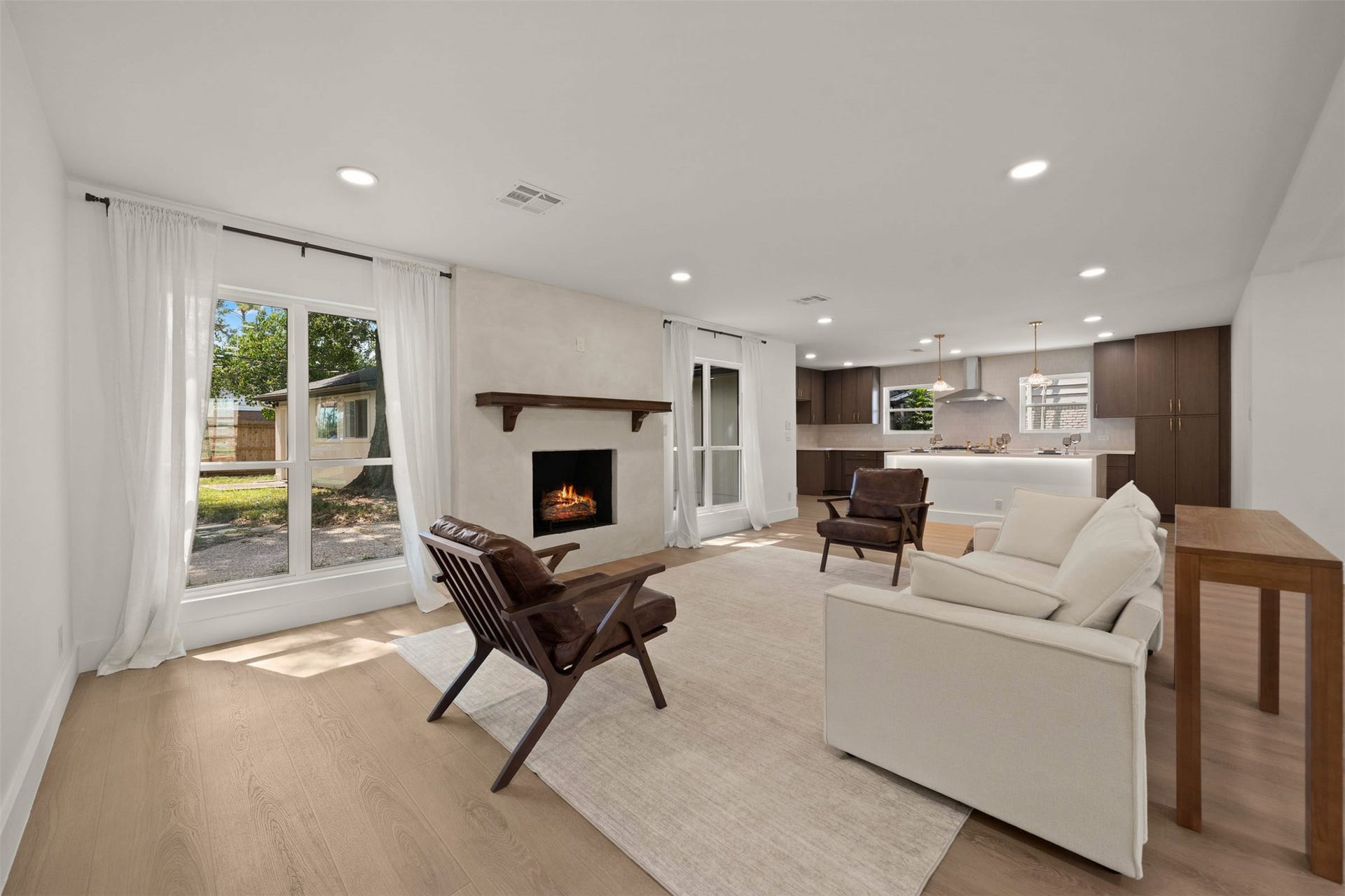 10111 Kerrwood Lane, Houston, TX 77080 The living area is anchored by a stunning fireplace, adding warmth and character to the space- perfect for cozy nights at home as the holiday season approaches.