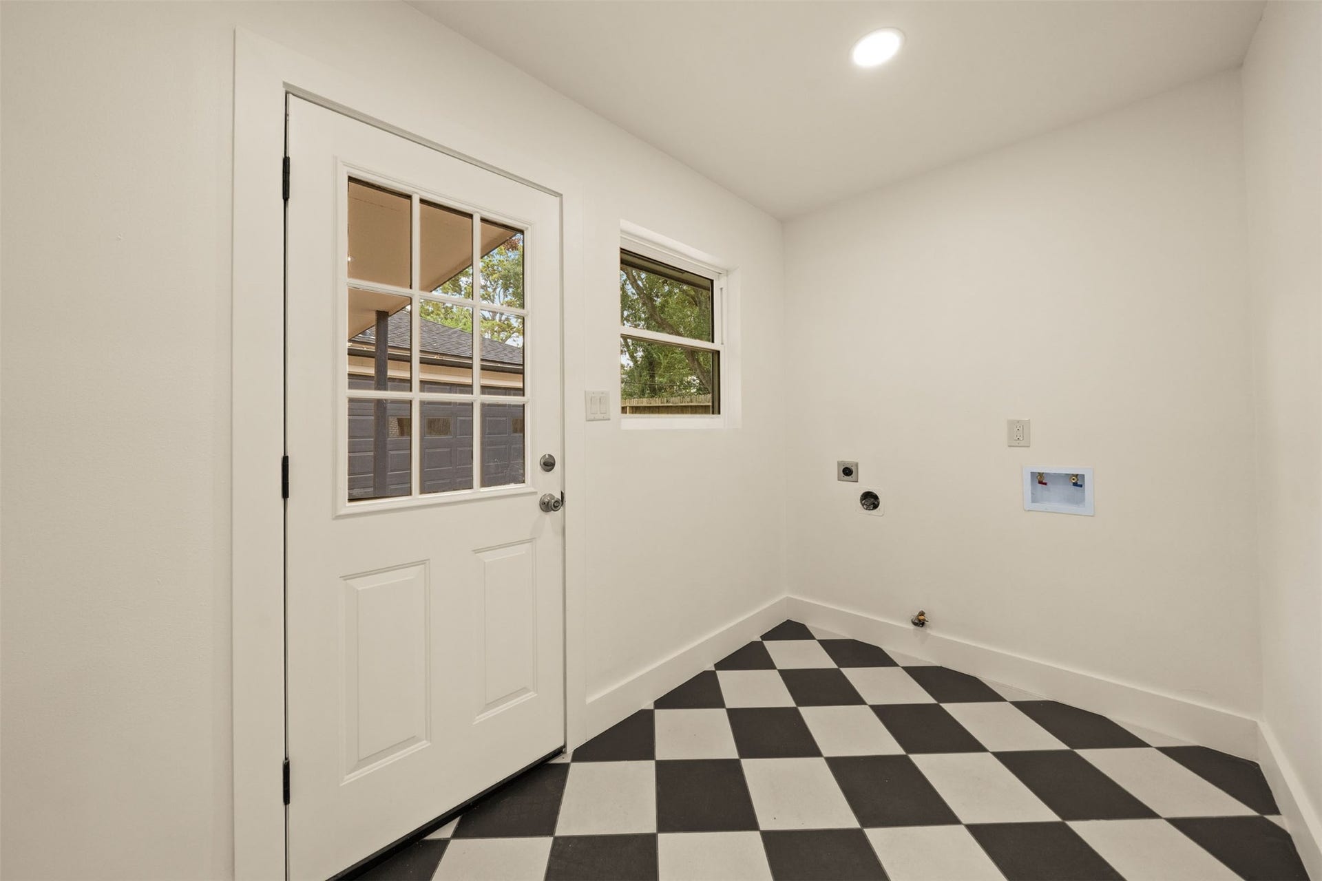 10111 Kerrwood Lane, Houston, TX 77080 The utility room features charming checkerboard flooring, adding a stylish touch to this functional space.