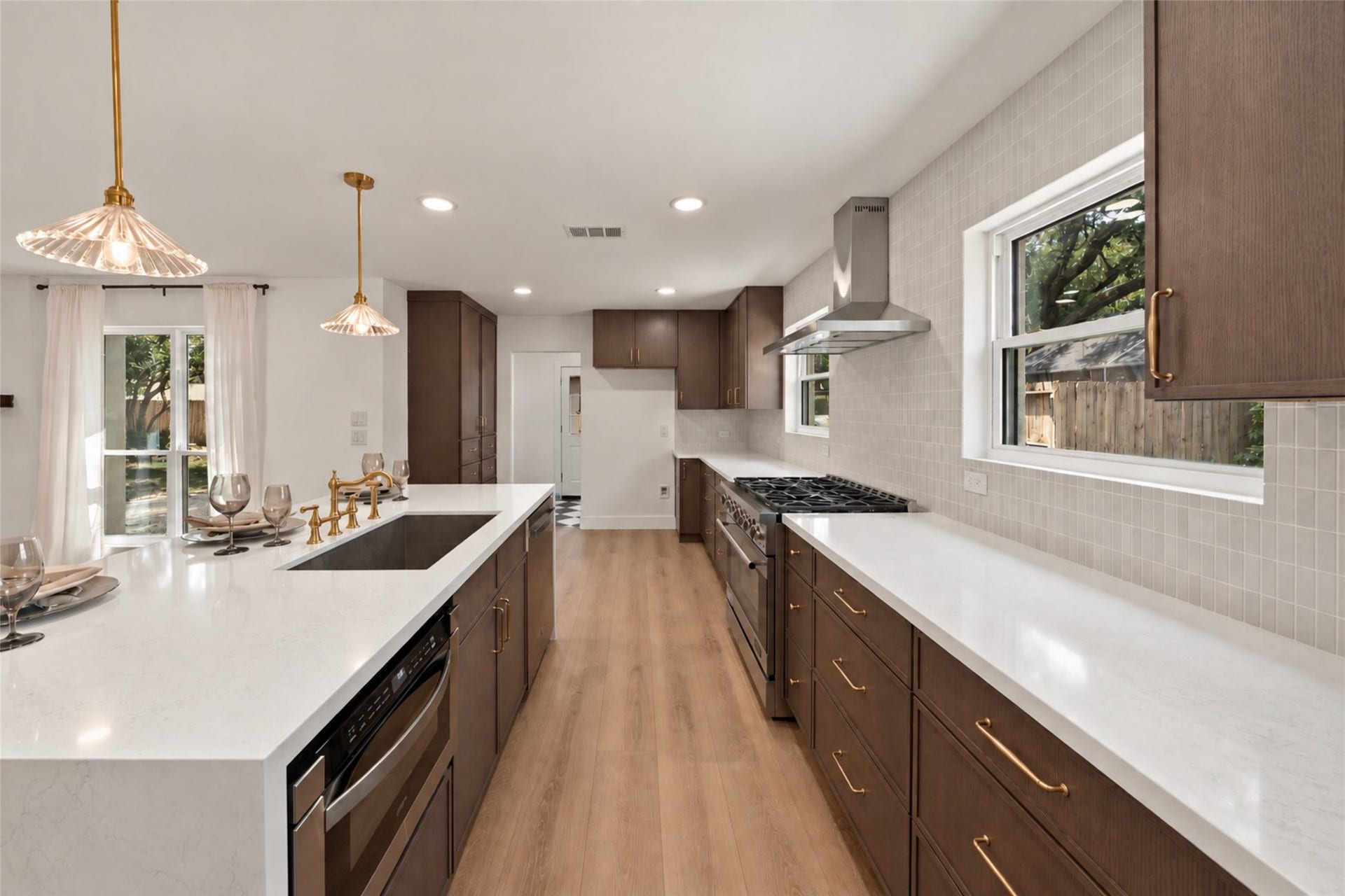 10111 Kerrwood Lane, Houston, TX 77080 Stainless steel appliances include a sleek microwave drawer and a 36-inch range complemented by a SS vent hood.
