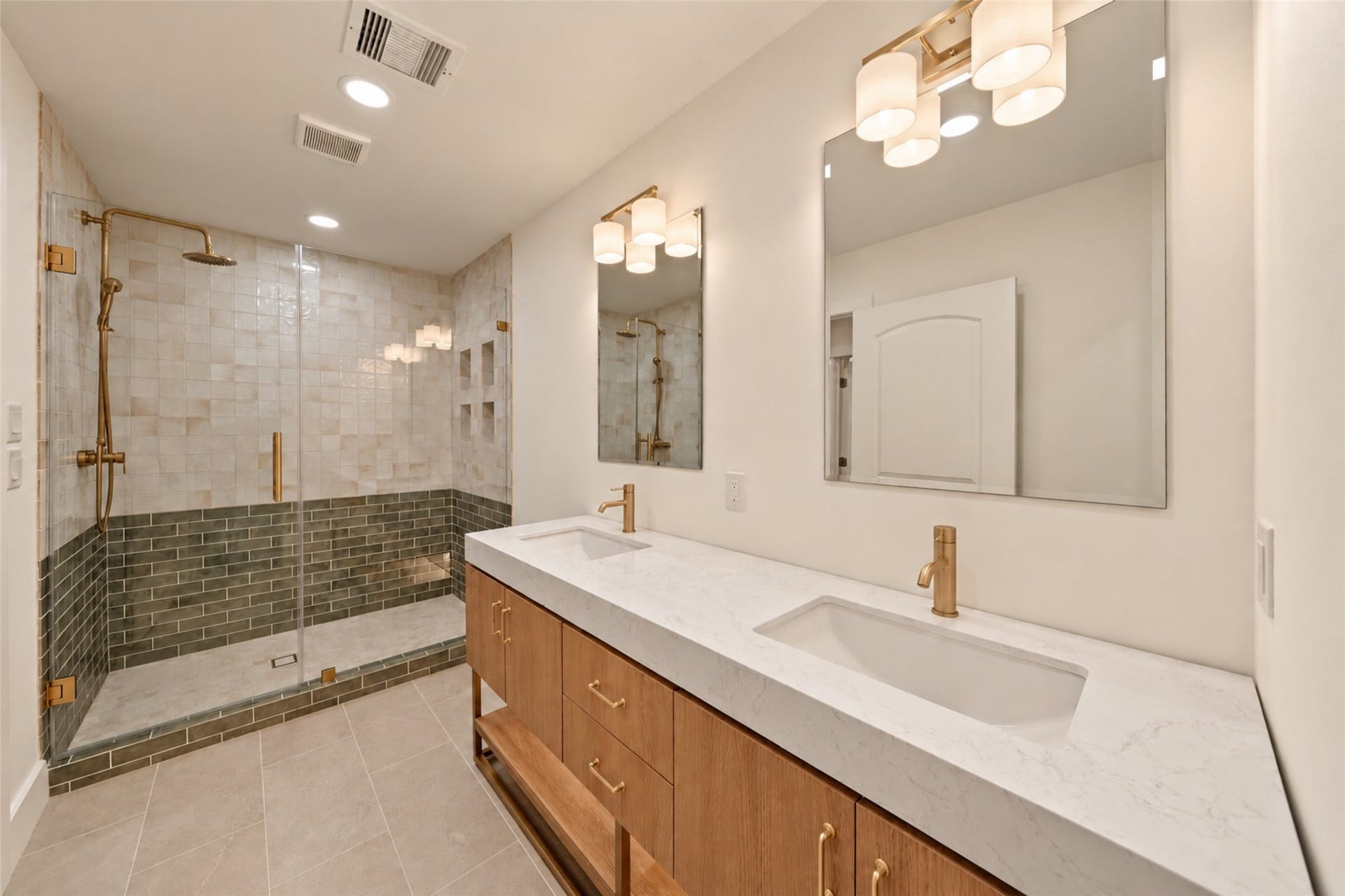 10111 Kerrwood Lane, Houston, TX 77080 The primary bath features beautiful tilework, a spacious dual-sink vanity, oversized walk-in shower, and private water closet.