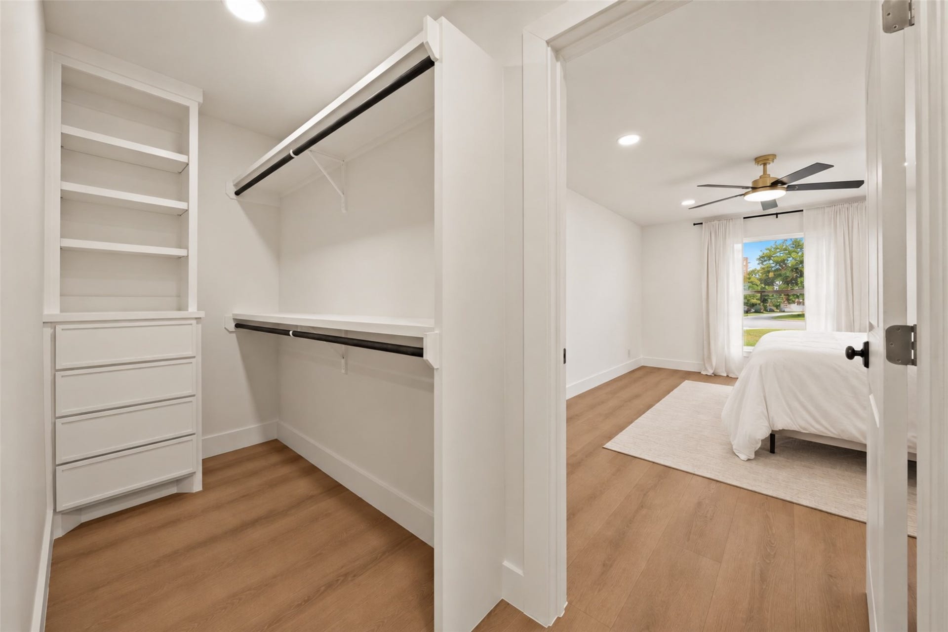 10111 Kerrwood Lane, Houston, TX 77080 The primary suite features separate his-and-hers walk-in closets, offering built in storage and shelving for convenient organization.