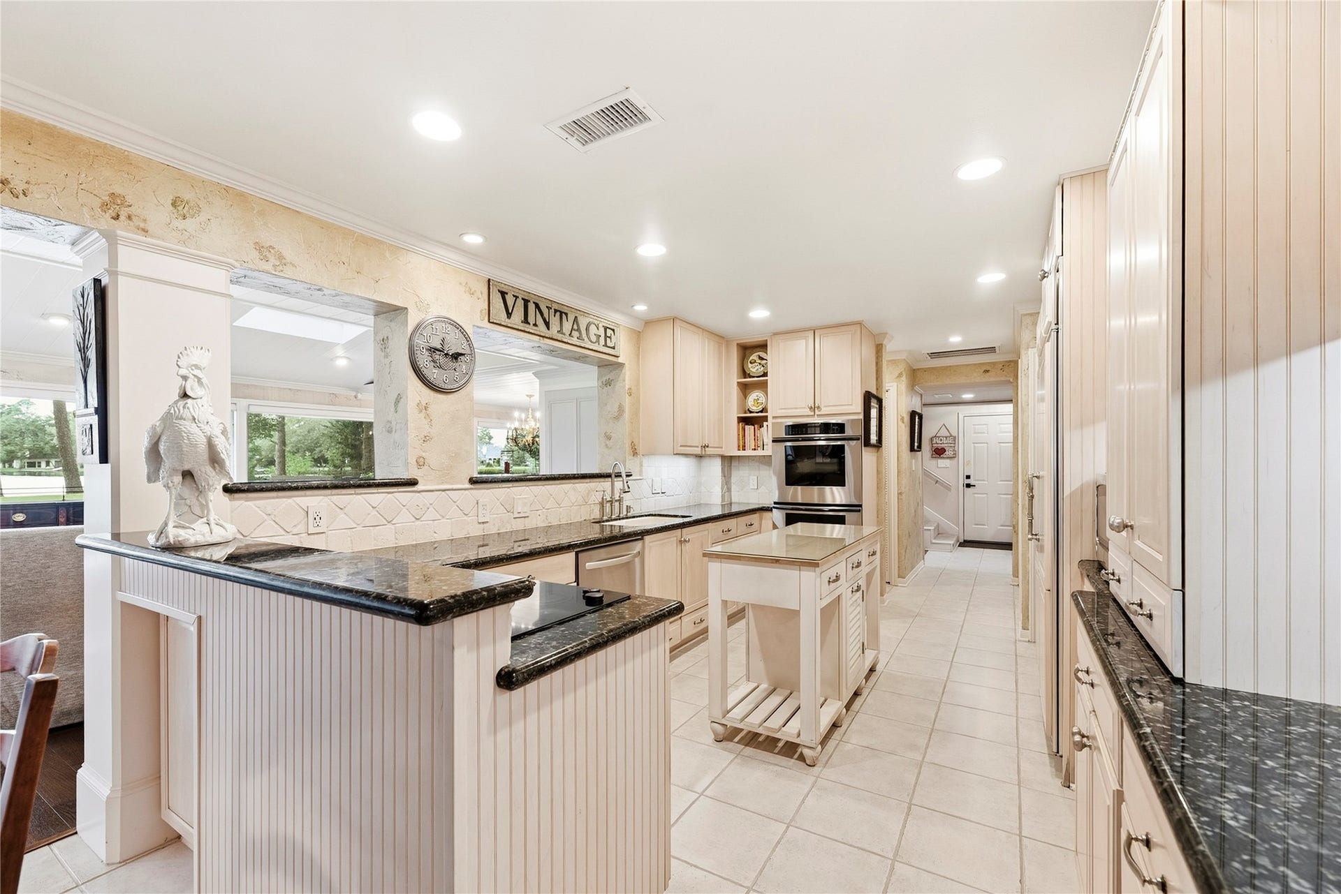 13131 Holston Hills Drive, Houston, TX 77069 Timeless kitchen complete with granite countertops, Thermador double ovens, wood-paneled sub-zero refrigerator, recessed lights and more.