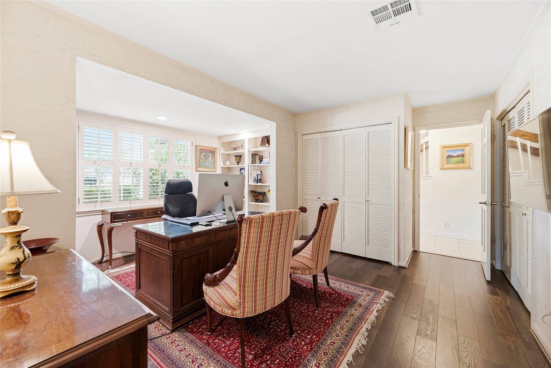 13131 Holston Hills Drive, Houston, TX 77069 First floor bedroom, complete with large windows and two closets, neutral paint, and beautiful wood floors - currently used as an office.