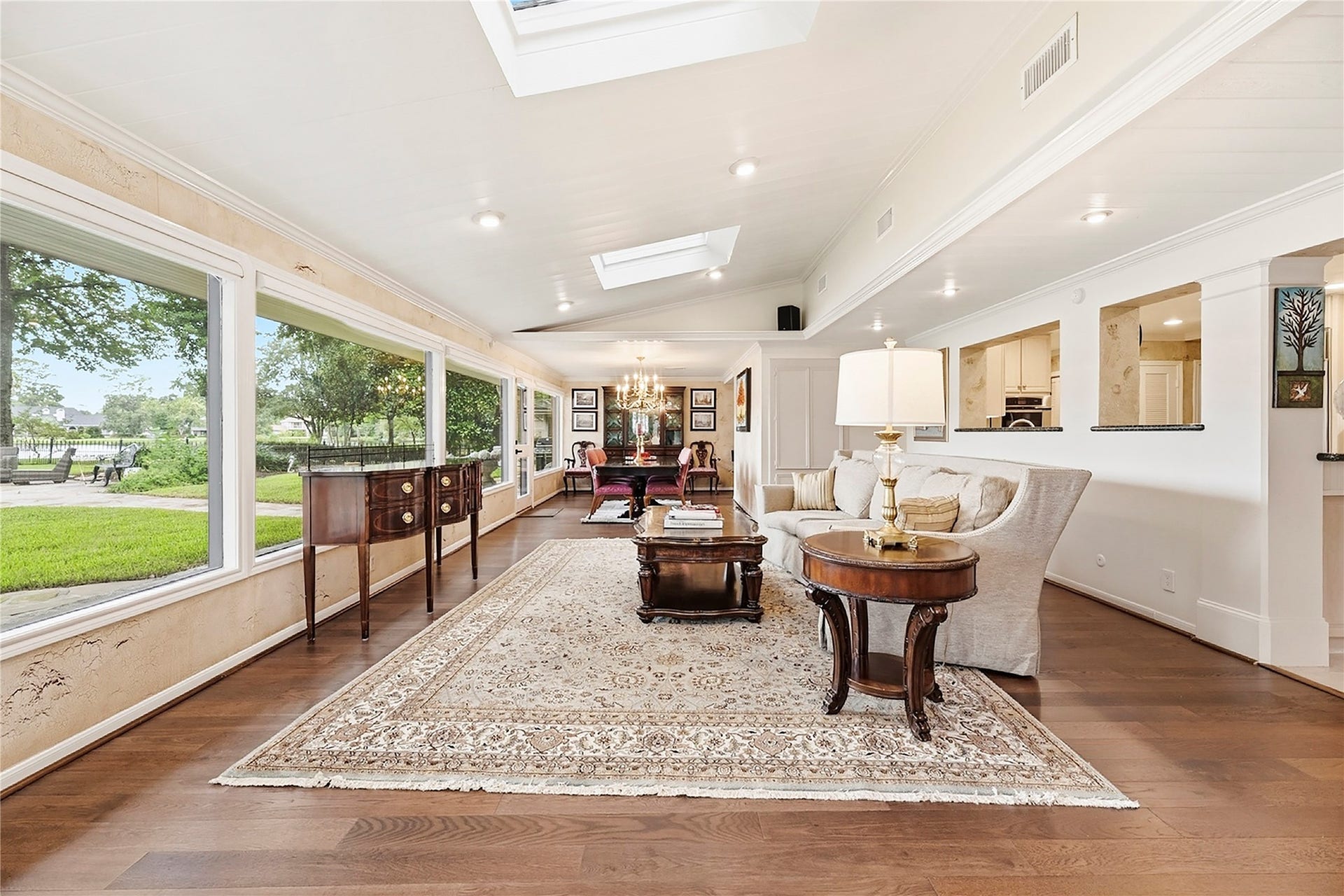 13131 Holston Hills Drive, Houston, TX 77069 Heart of the home with a wall of windows, beautiful wood floors, sky lights, and recessed lights.