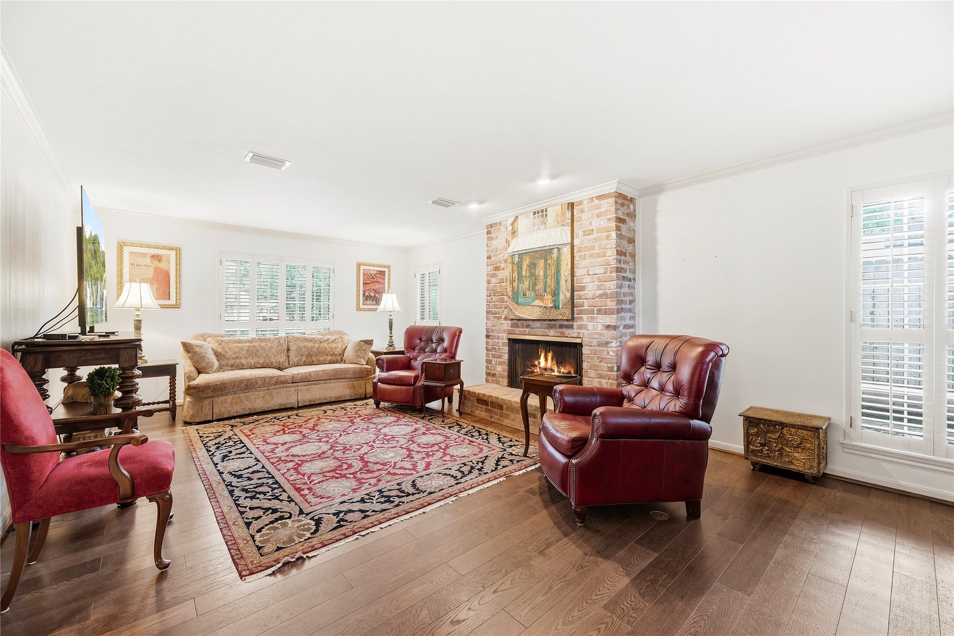 13131 Holston Hills Drive, Houston, TX 77069 Spacious family room/den. Complete with wood floors, neutral paint, brick fireplace, and multiple large windows with plantation shutters.