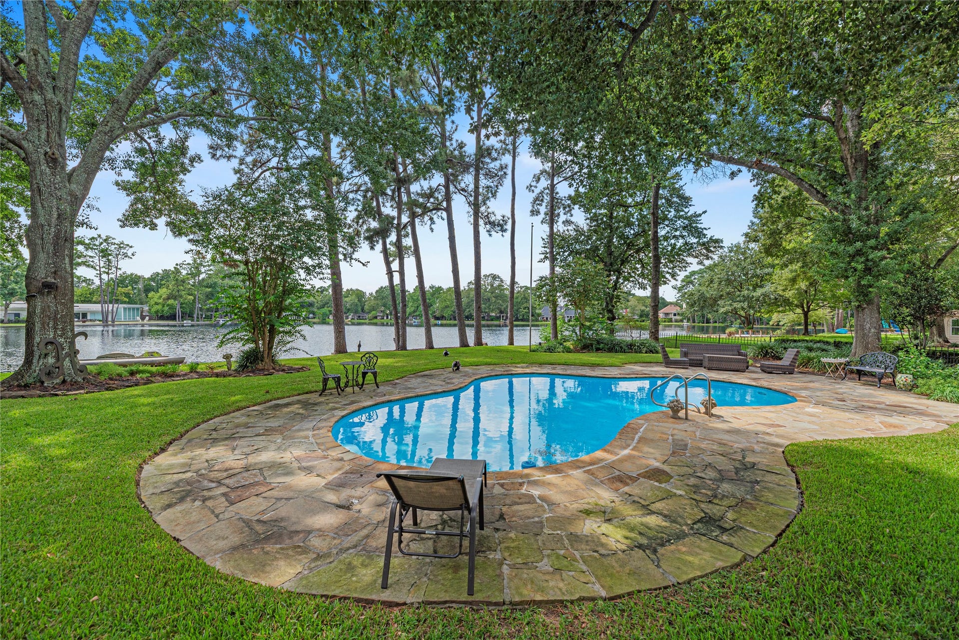 13131 Holston Hills Drive, Houston, TX 77069 Sparkling pool, expansive patio, lush green space, and 105' of lakefront.