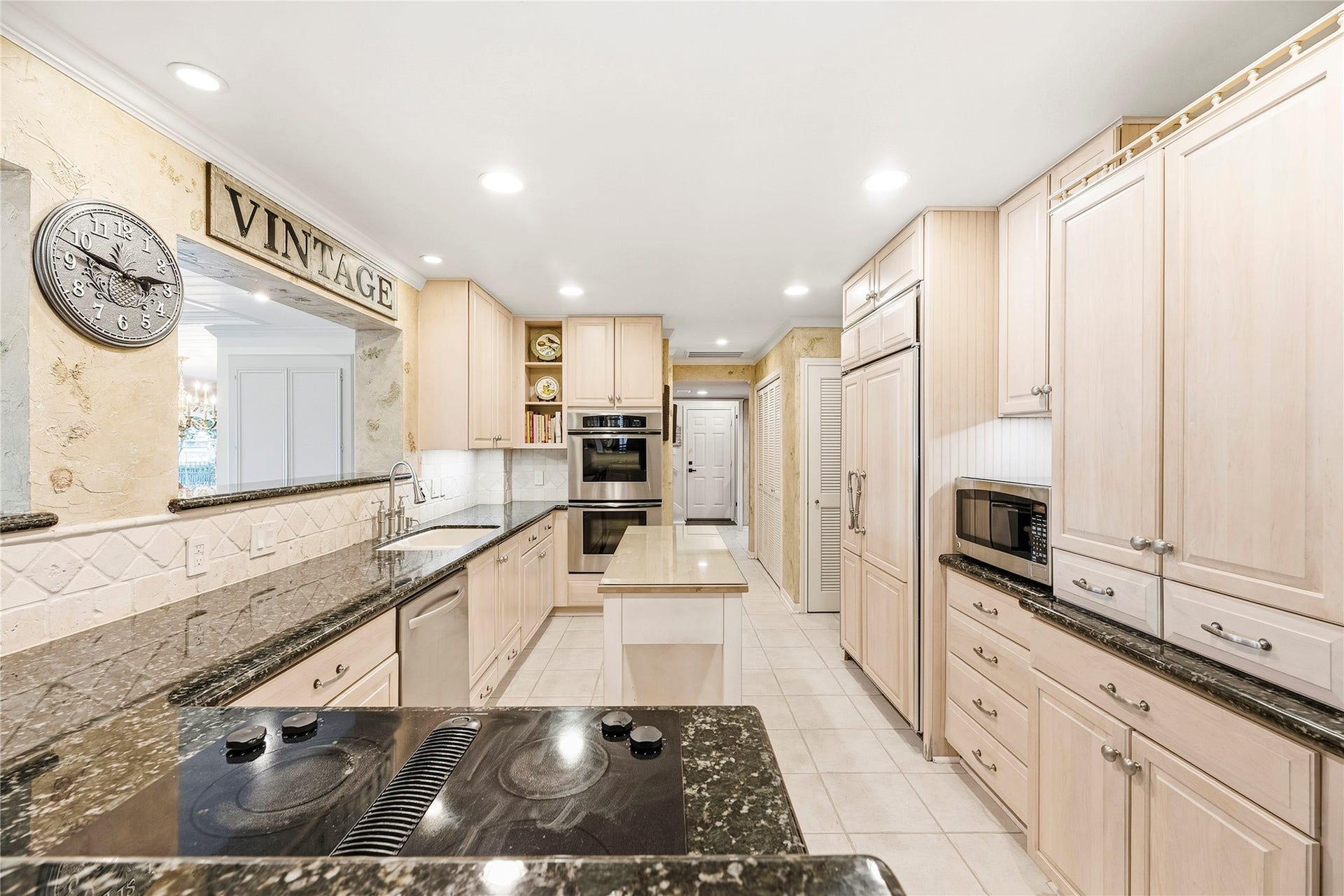 13131 Holston Hills Drive, Houston, TX 77069 Timeless kitchen complete with granite countertops, Thermador double ovens, wood-paneled sub-zero refrigerator, recessed lights and more.