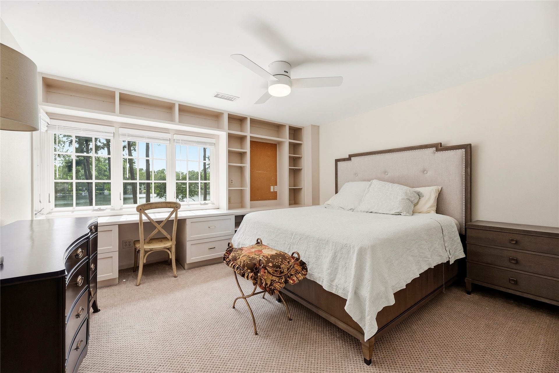 13131 Holston Hills Drive, Houston, TX 77069 Secondary bedroom with wonderful built ins, plush carpet, and lakefront views.