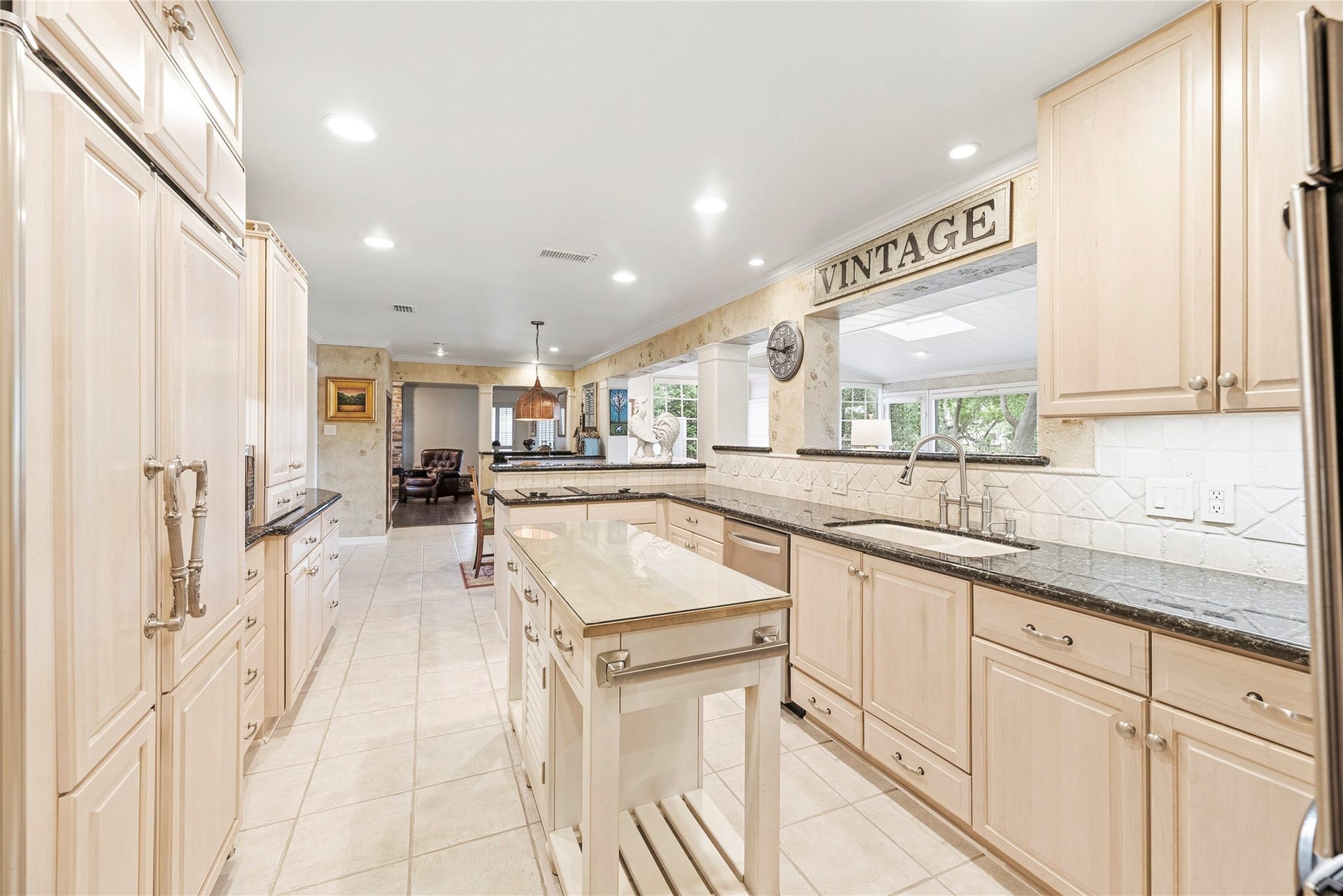 13131 Holston Hills Drive, Houston, TX 77069 Timeless kitchen complete with granite countertops, Thermador double ovens, wood-paneled sub-zero refrigerator, recessed lights and more.