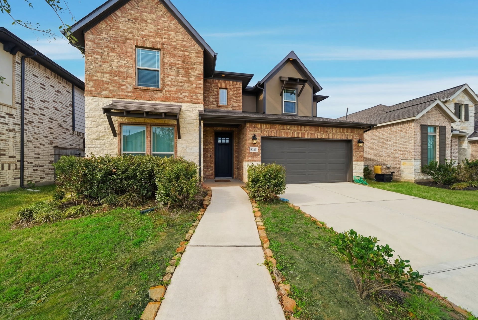 8815 Morning Glow Drive, Missouri City, TX 77459 This charming two-story home features a brick exterior, a spacious two-car garage, and a neatly landscaped front yard with a welcoming walkway.