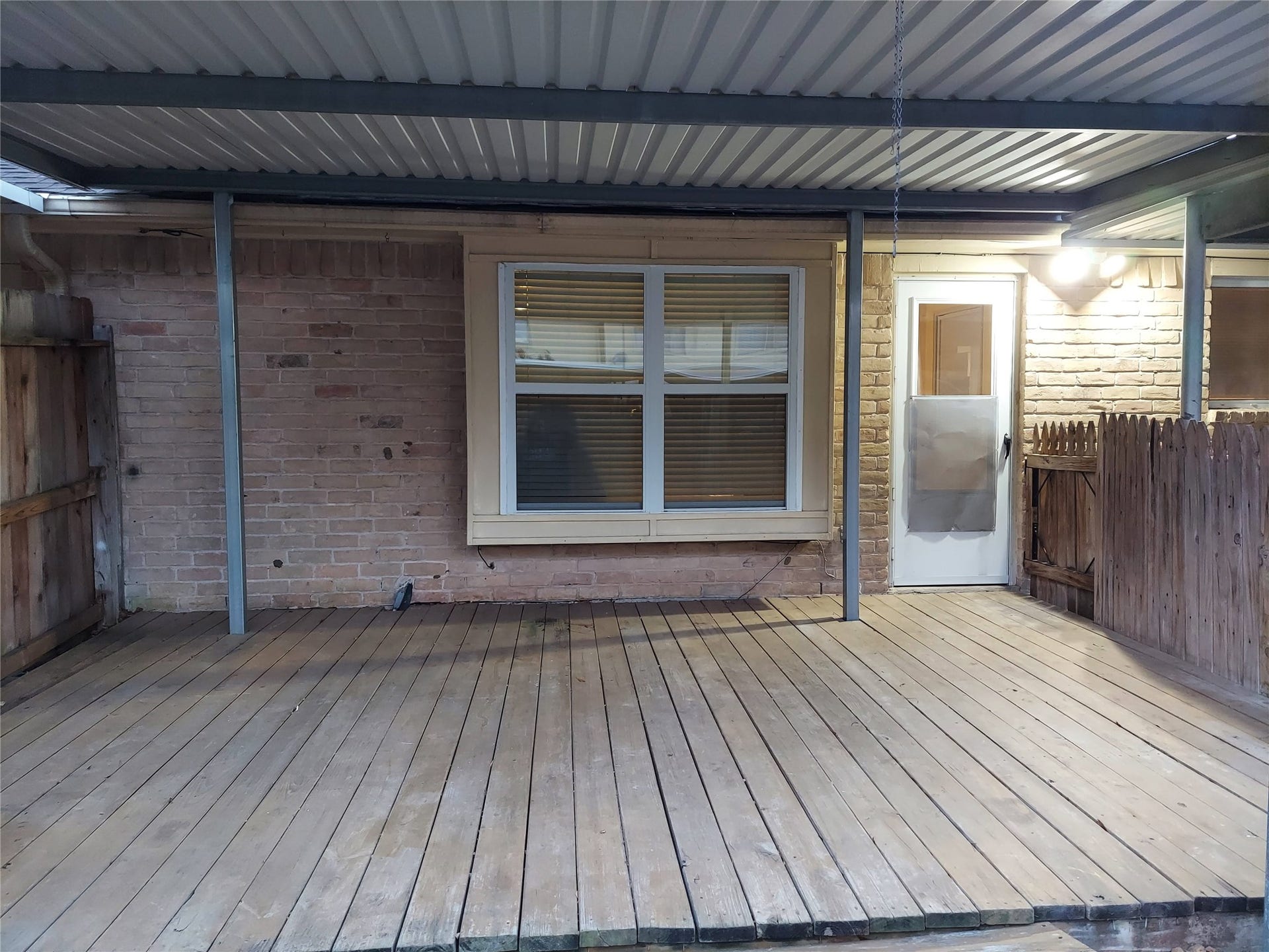 3878 Laura Leigh Drive, Friendswood, TX 77546 Cozy covered patio with wooden decking, perfect for outdoor relaxation and entertainment.