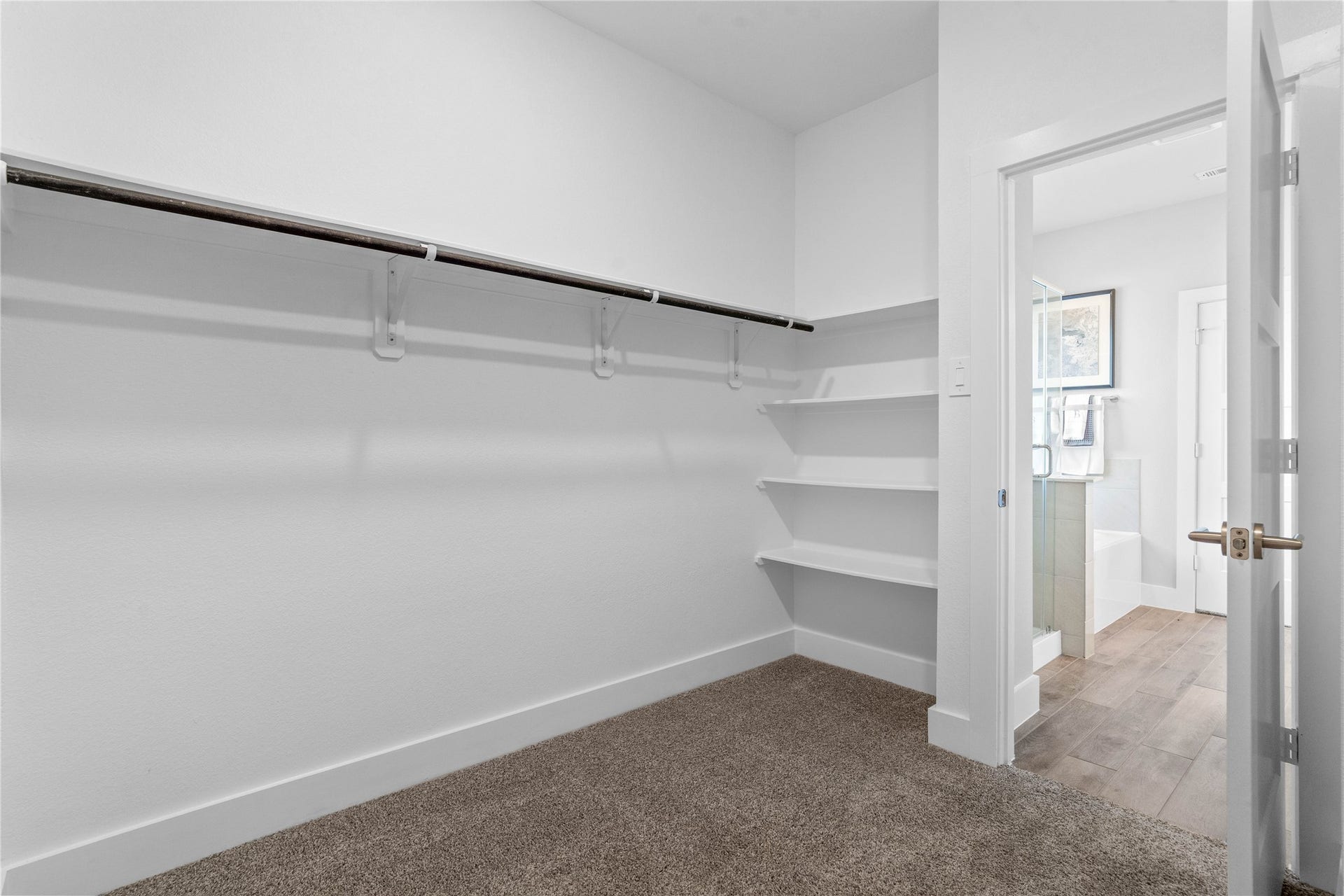 19608 Montgomery Ridge Way, Montgomery, TX 77316 The primary suite features a generous walk-in closet equipped with functional hanging rods and shelving.