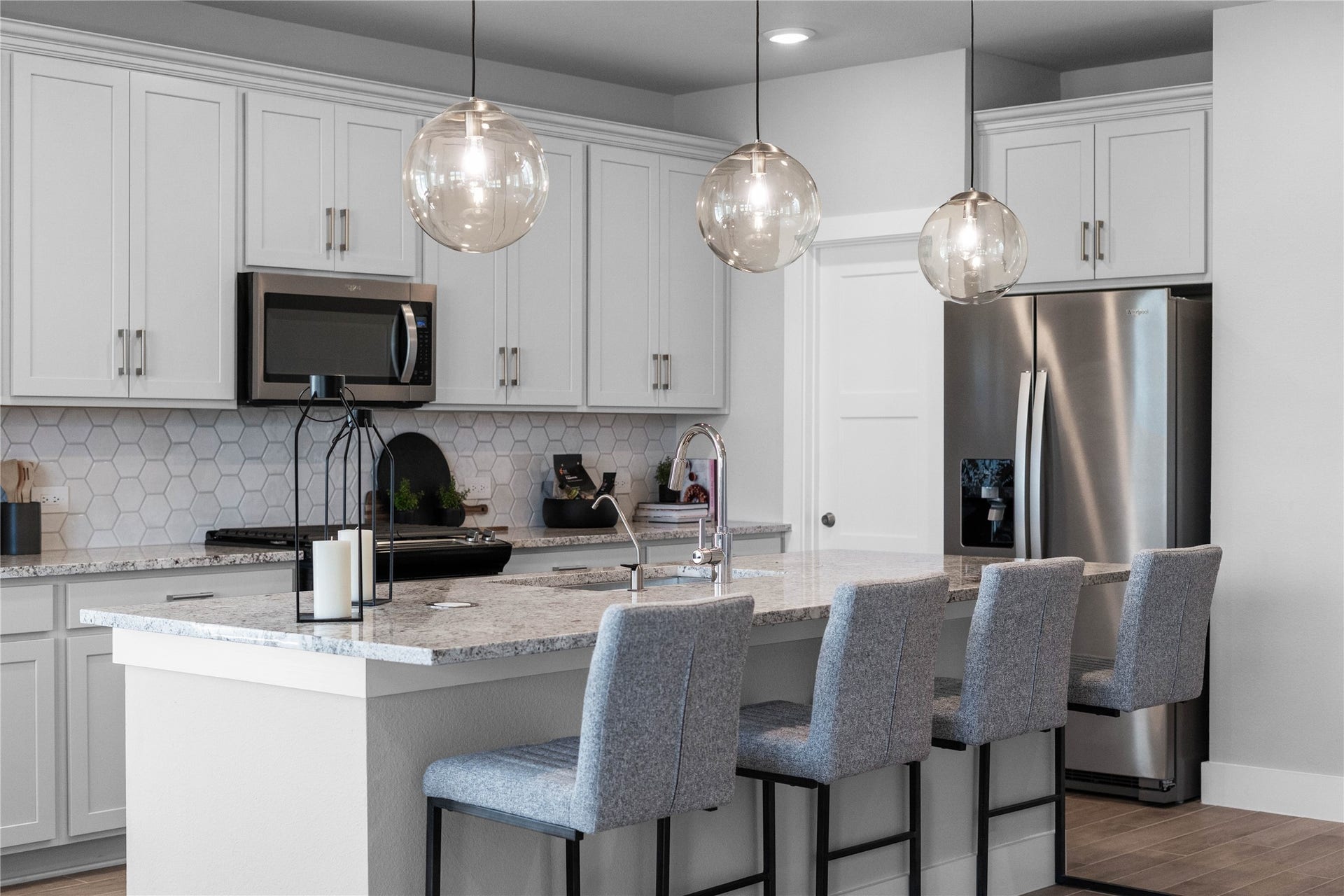 19608 Montgomery Ridge Way, Montgomery, TX 77316 The extended granite kitchen island creates a convenient breakfast bar, providing a casual and inviting space where stools can be added for quick meals or long conversations.