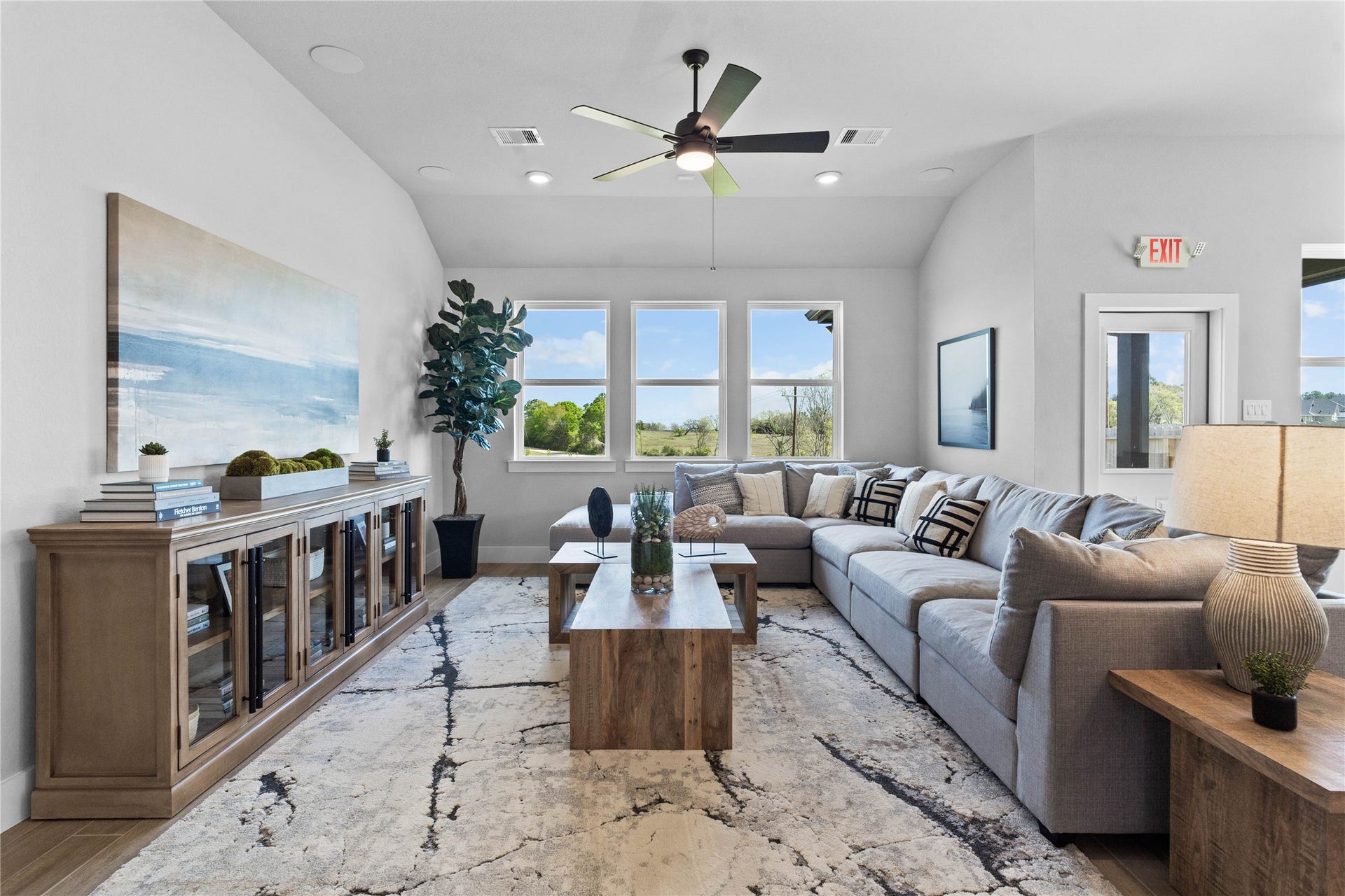 19608 Montgomery Ridge Way, Montgomery, TX 77316 This sun-drenched sanctuary where soaring sloped ceilings and wood-look tile flooring meet. This seamless open-concept space is perfectly illuminated by recessed lighting and a wall of windows, while a ceiling fan keeps the room comfortable year-round.