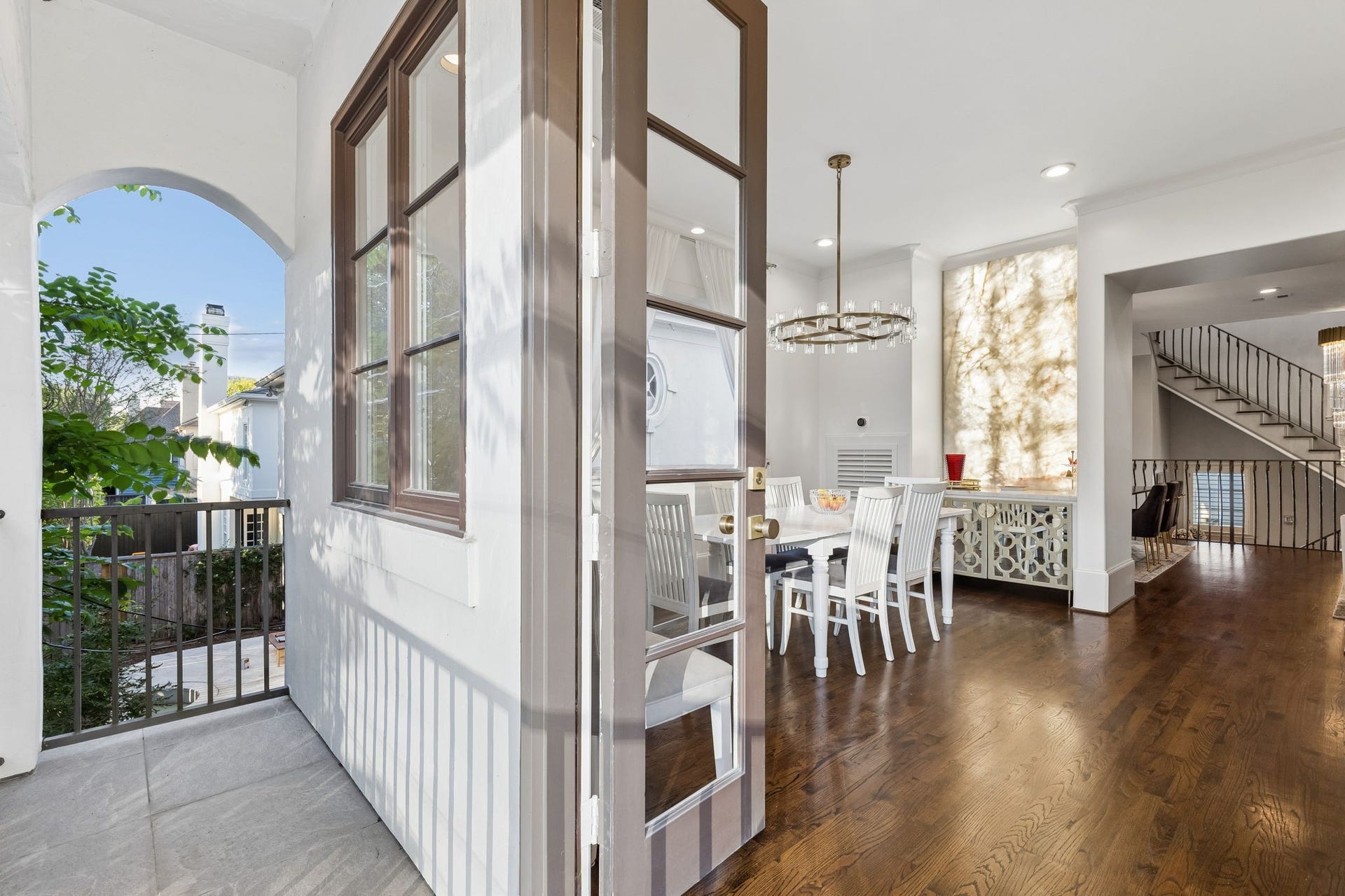 Extending the kitchen's entertaining  space, the second-floor balcony rovides the perfect outdoor space for entertaining guests or enjoying a peaceful retreat.