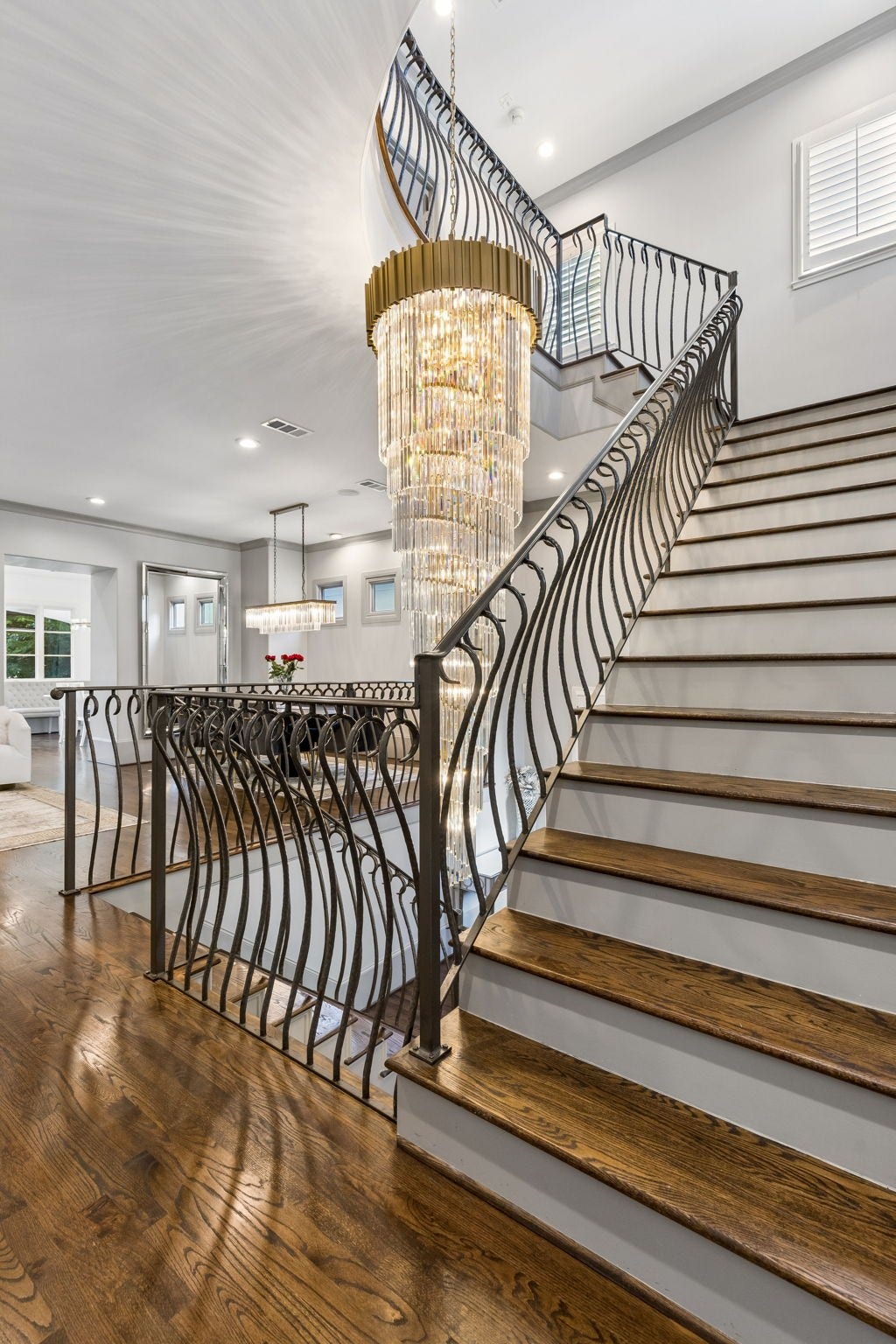 Welcome home to this beautifully renovated three-story residence featuring a striking modern horizontal plank wood front door and timeless architectural appeal.
