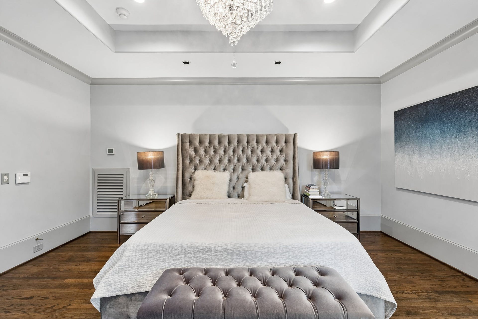 Double-door entry and a beautiful tray ceiling elevate the room's sense of elegance and scale.