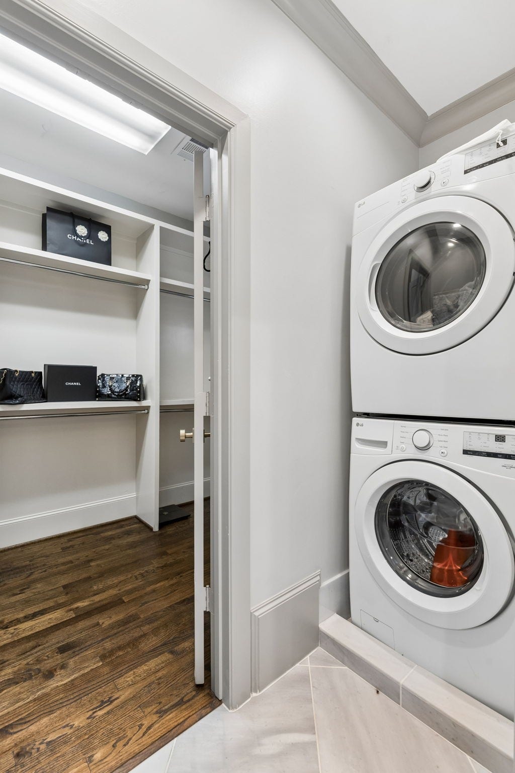 Enhancing the home's thoughtful design, the third-floor bathroom includes a discreet stackable washer and dryer, offering a convenient secondary laundry station that complements the primary laundry room.