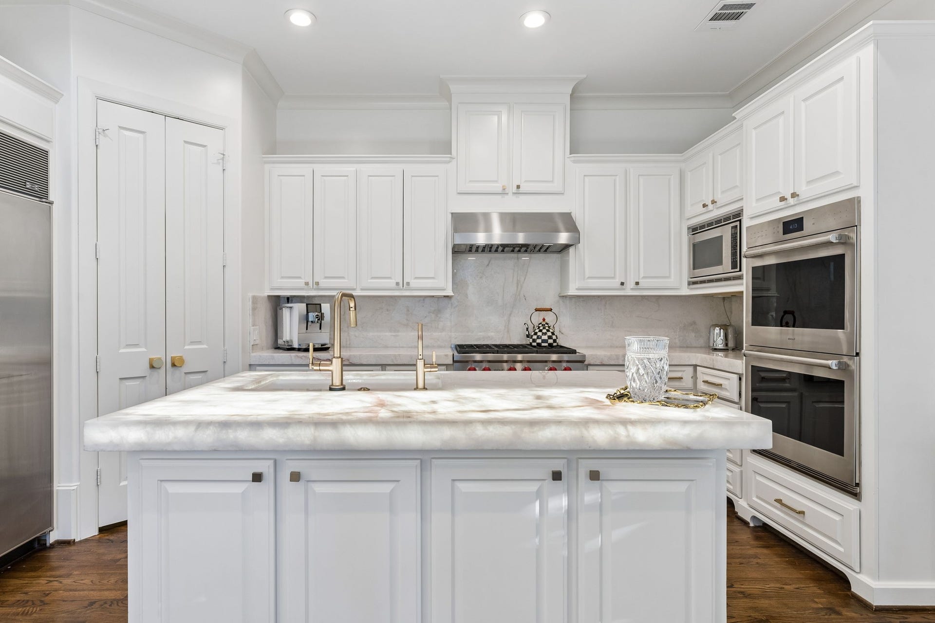 A suite of premium Wolf appliances, including a gas cooktop and double ovens, delivers exceptional culinary performance.