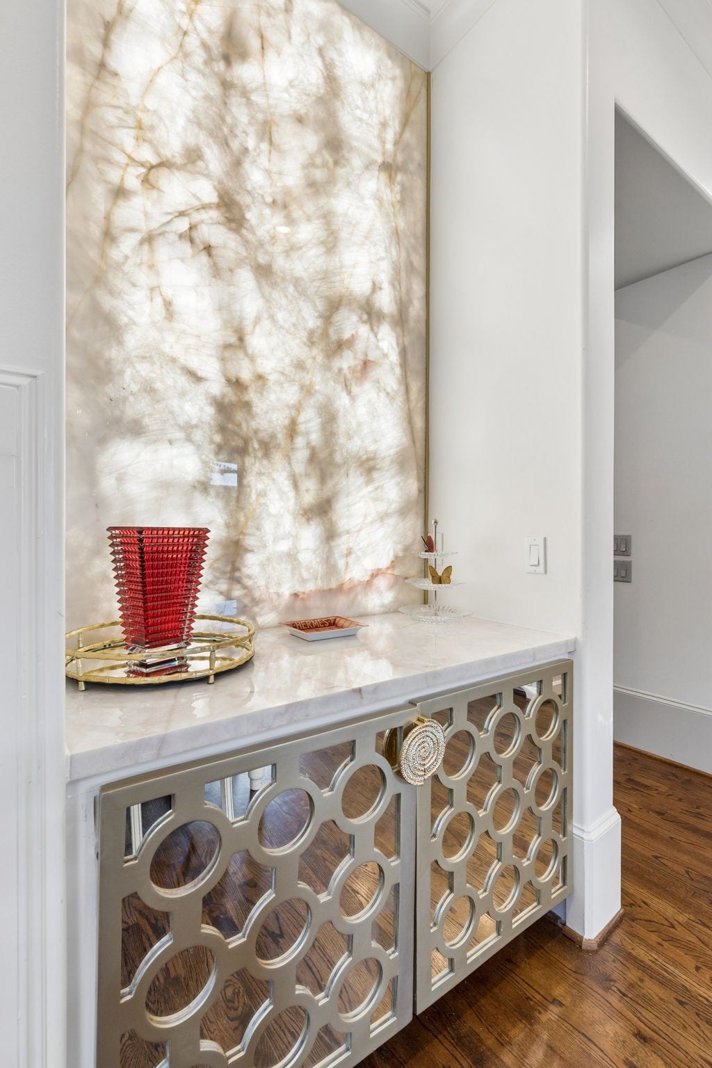 Custom illuminated Quartzite custom wall panel, custom made built-in cabinetry with pull out storage trays.