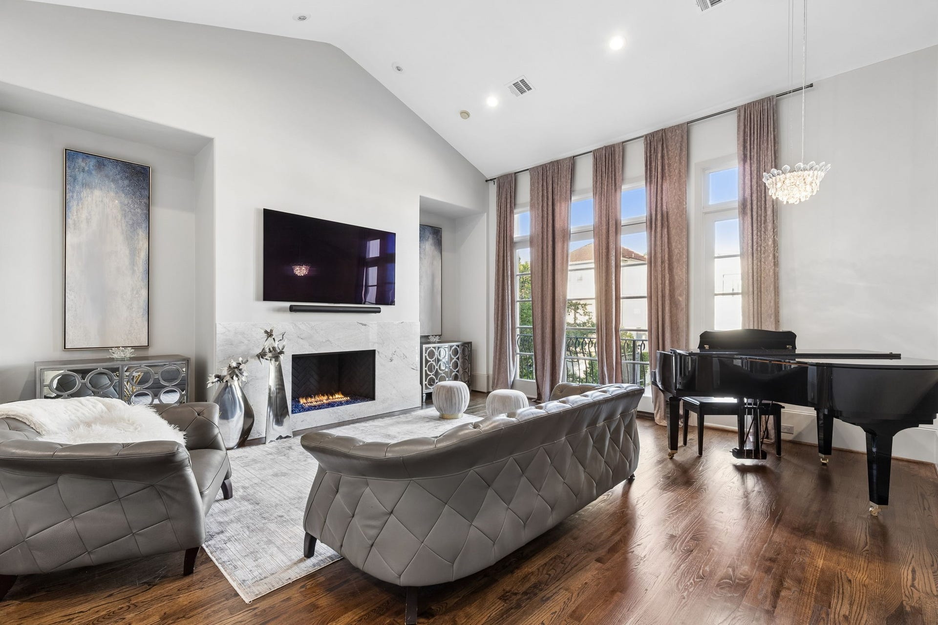 Designed to make a lasting impression, the expansive 20'10" x 26'5" living room showcases soaring ceilings, a beautiful fireplace, and spectacular two-story windows that bathe the space in natural light while highlighting the home's timeless architectural elegance.