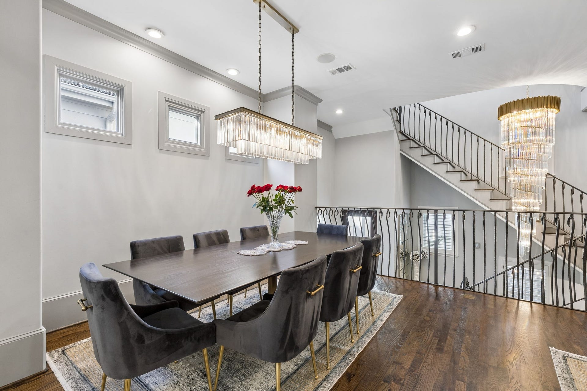 Designed for refined entertaining, the elegant dining room (approximately 8'3" x 13'10") offers an intimate yet sophisticated setting for formal dining. A stunning rectangular crystal linear chandelier anchors the space with timeless elegance, while thoughtfully placed in-floor electrical outlets with brass covers enhance both functionality and design flexibility.