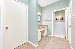 Spacious bathroom with a large vanity, ample storage, and soothing light blue walls.