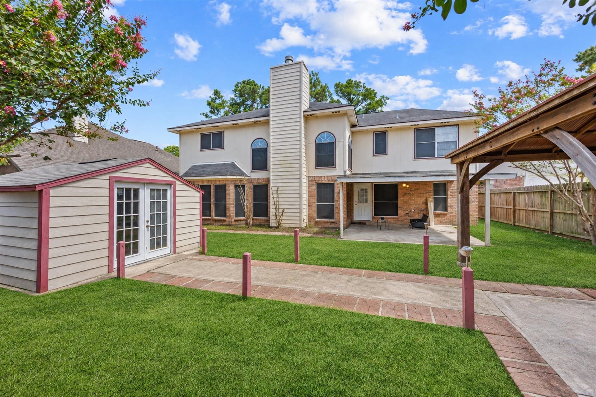 19119 Timber Trace Drive, Humble, TX 77346 Spacious backyard with a charming patio area, storage shed, and a covered gazebo, perfect for outdoor entertaining.