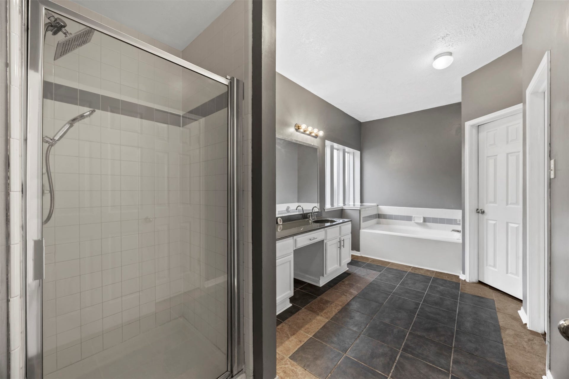 19119 Timber Trace Drive, Humble, TX 77346 Spacious bathroom featuring a walk-in shower, large soaking tub, and dual sinks with modern fixtures.