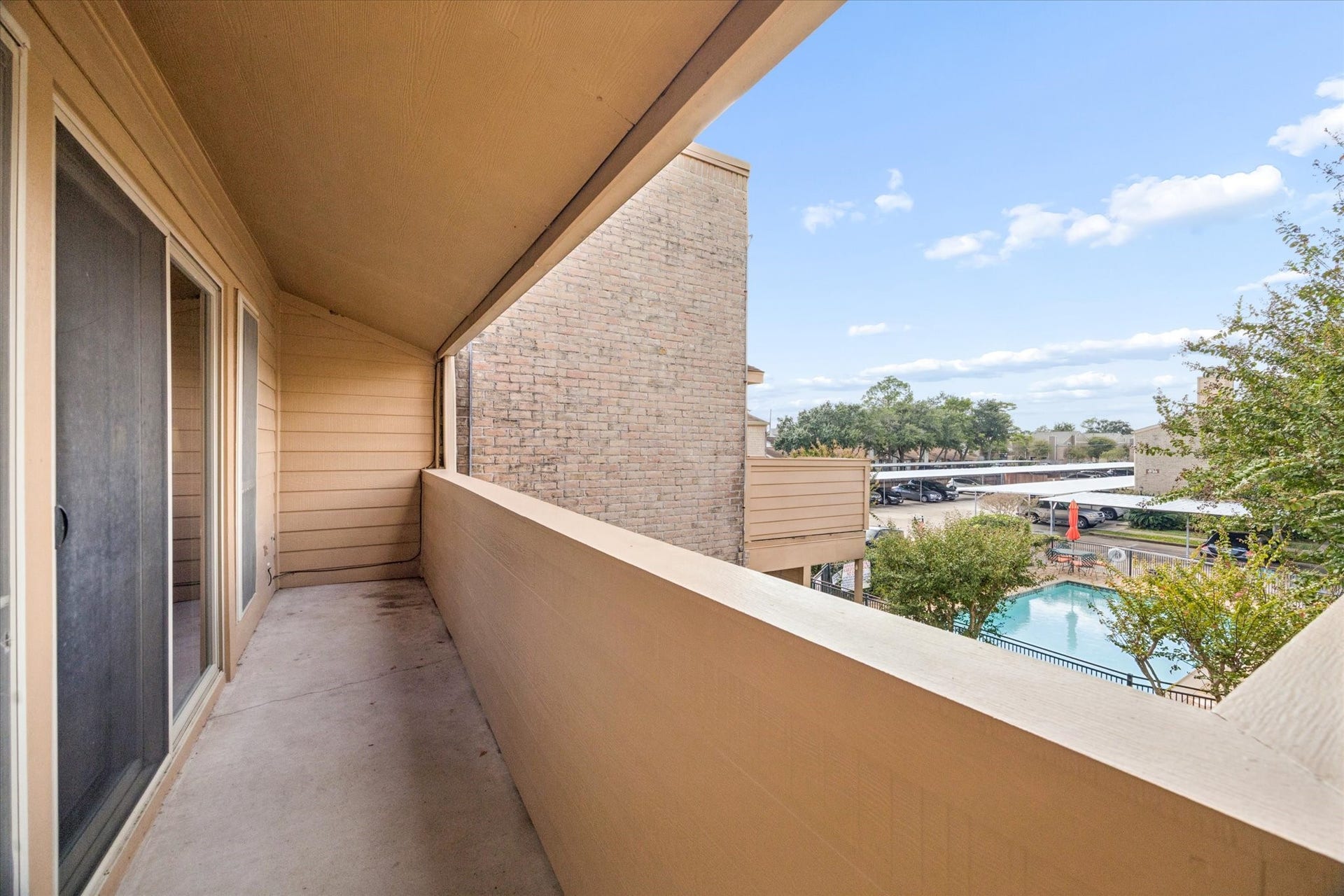 1915 Augusta Drive, #43, Houston, TX 77057 Private covered patio overlooking the community pool, offering a relaxing outdoor space just steps from the unit.