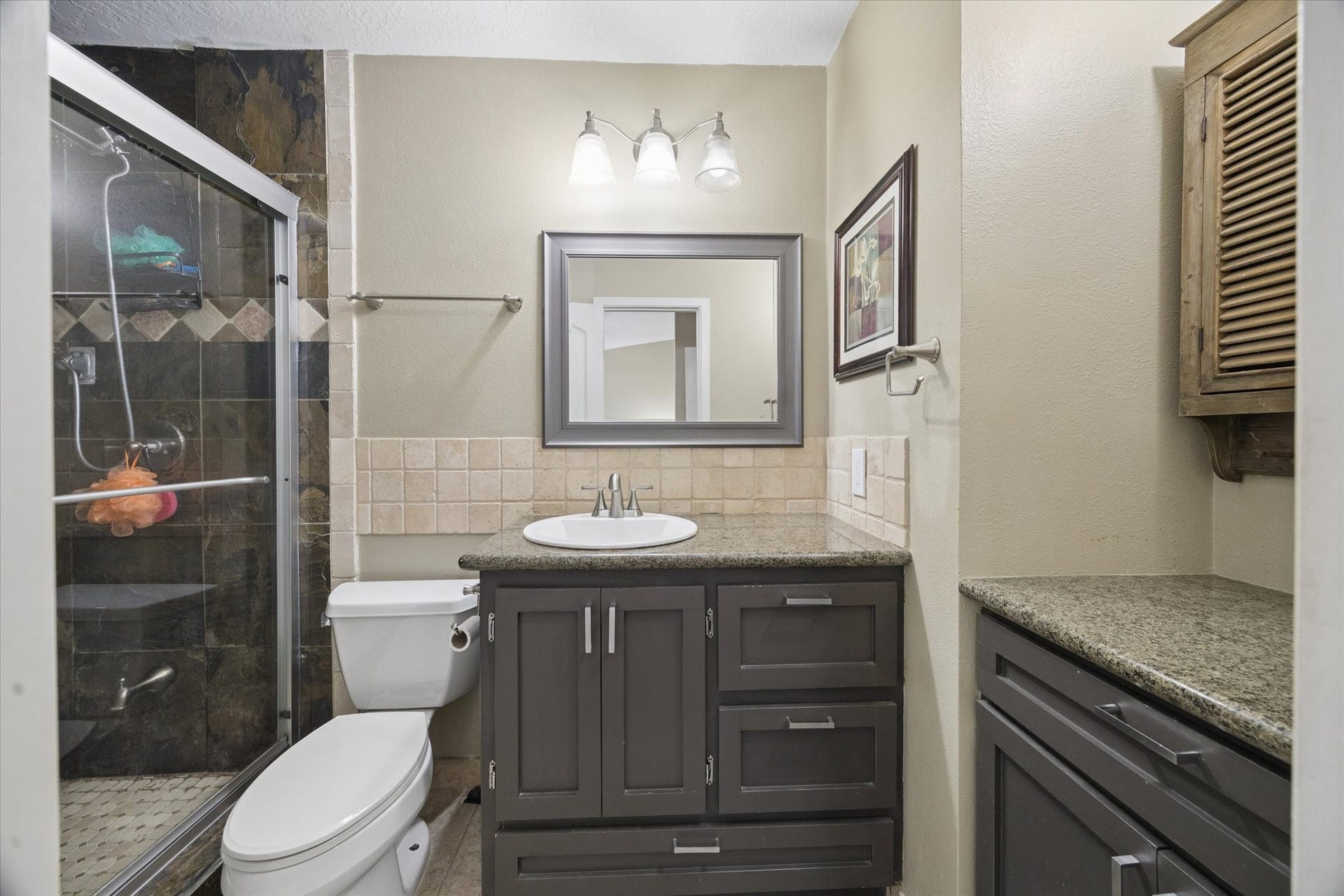 1915 Augusta Drive, #43, Houston, TX 77057 Updated bathroom featuring a walk-in shower with glass enclosure, modern vanity, tile flooring, and a clean, neutral finish.
