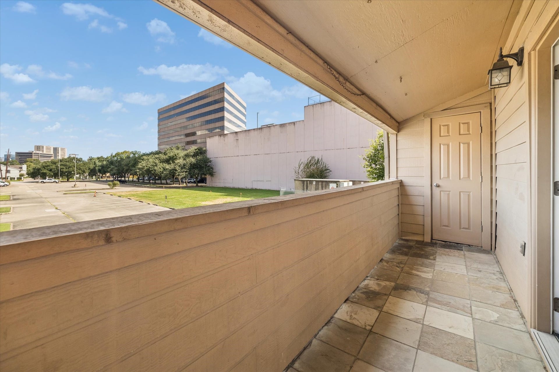 1915 Augusta Drive, #43, Houston, TX 77057 Private patio directly off the primary bedroom, offering a quiet outdoor retreat with space to relax and enjoy fresh air.