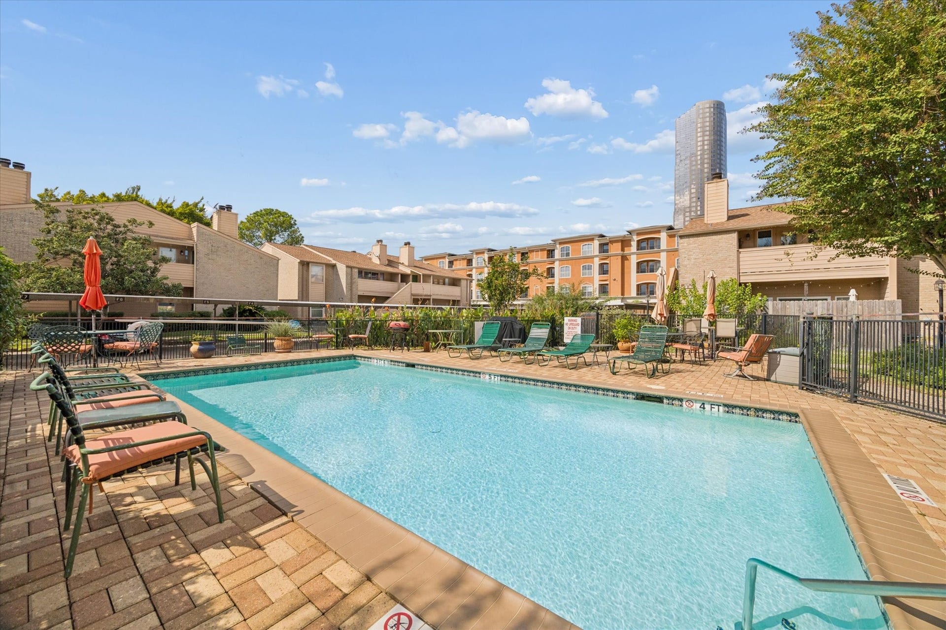 1915 Augusta Drive, #43, Houston, TX 77057 Resort-style community pool surrounded by landscaped grounds and ample lounging space, offering a relaxing retreat just steps from the unit.