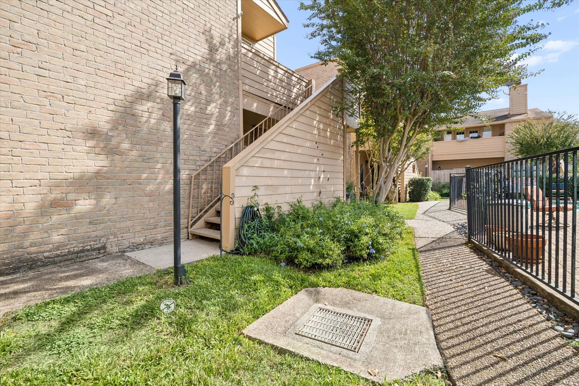 1915 Augusta Drive, #43, Houston, TX 77057 Second-floor unit with exterior stair access and a pleasant view overlooking the community pool and landscaped grounds.