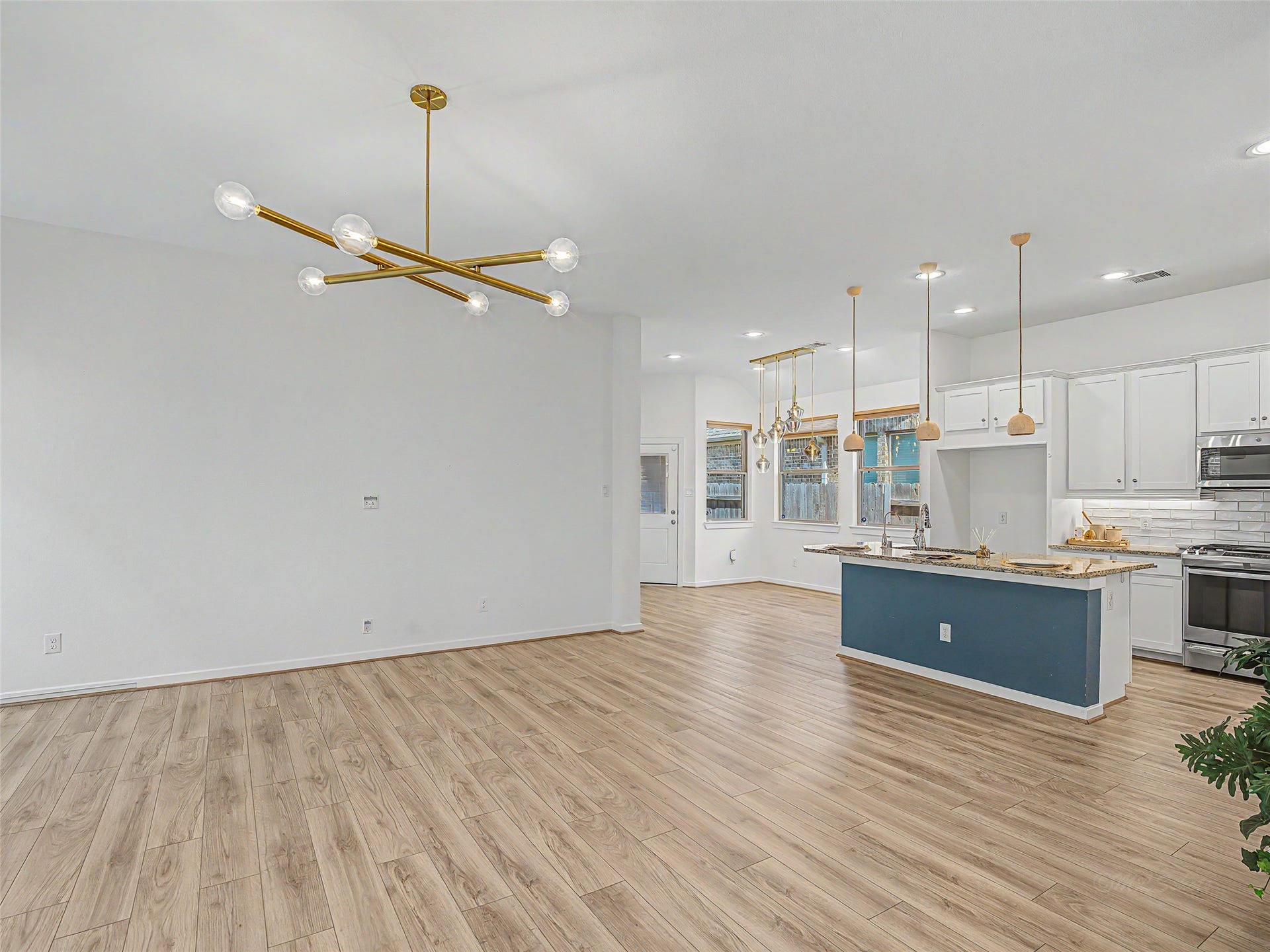 6019 Dovetail Cliff Court, Katy, TX 77493 Upon entry, the bright and inviting atmosphere is established by large windows that flood the room with natural light, complementing the extensive, light-toned wood-plank flooring that stretches throughout.