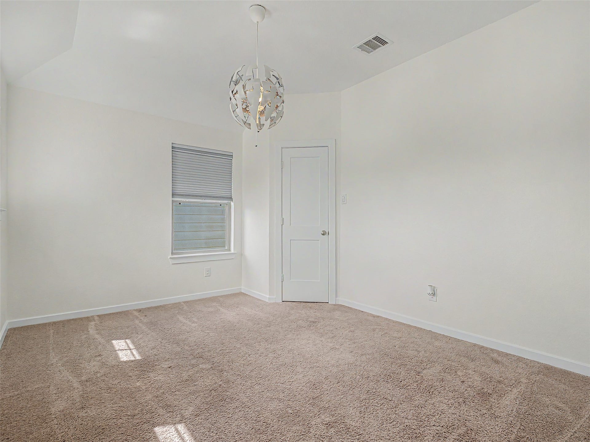 6019 Dovetail Cliff Court, Katy, TX 77493 This additional upstairs bedroom offers a unique, contemporary orb pendant light fixture that casts artful illumination throughout the space.The room features a private closet door and ample wall space, making it an ideal layout for a bedroom, nursery, or creative studio space.