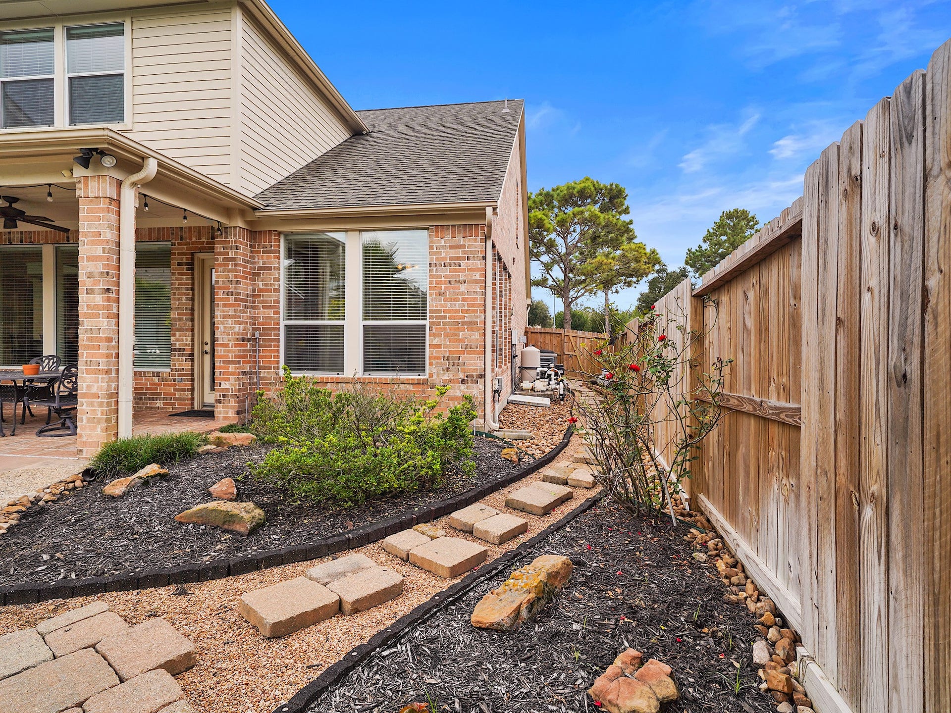 25610 Skye Springs Lane, Katy, TX 77494 A thoughtfully landscaped side passage offers practical access around the home while maintaining a polished exterior.
