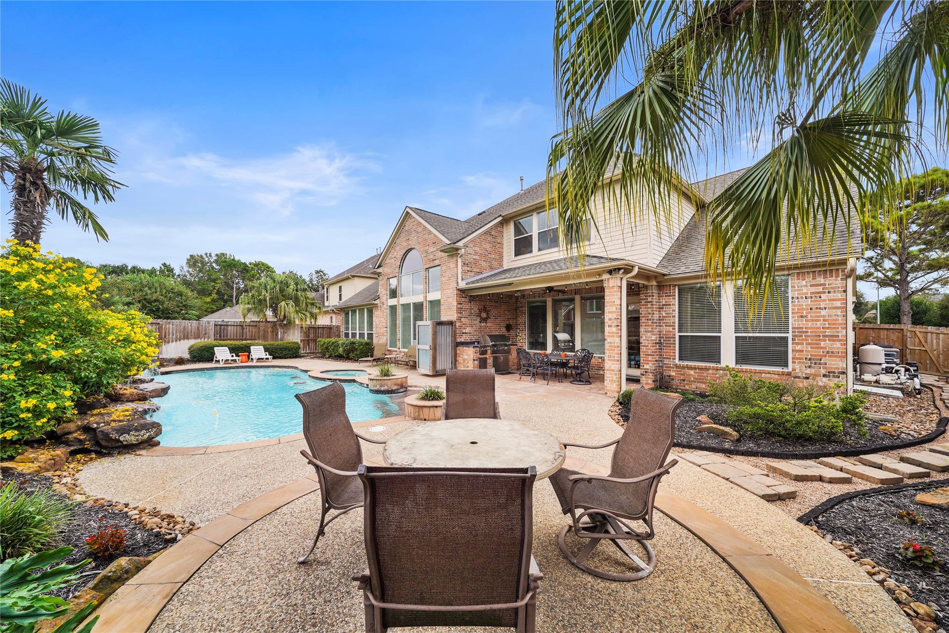 25610 Skye Springs Lane, Katy, TX 77494 Framed by tropical landscaping and generous patio space, the pool and spa create a private backyard escape for sunny Texas days.