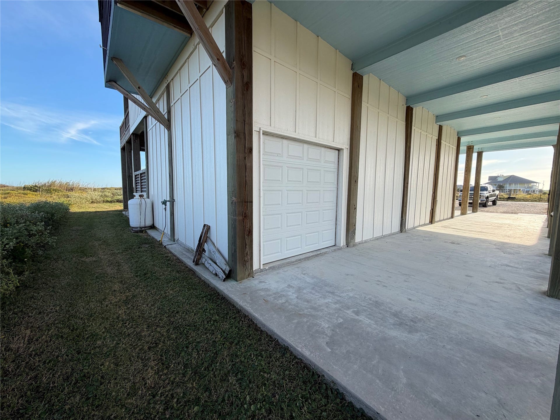 715 Magnolia Lane, Port Bolivar, TX 77650 View from Northwest corner of garage with additional rollup door