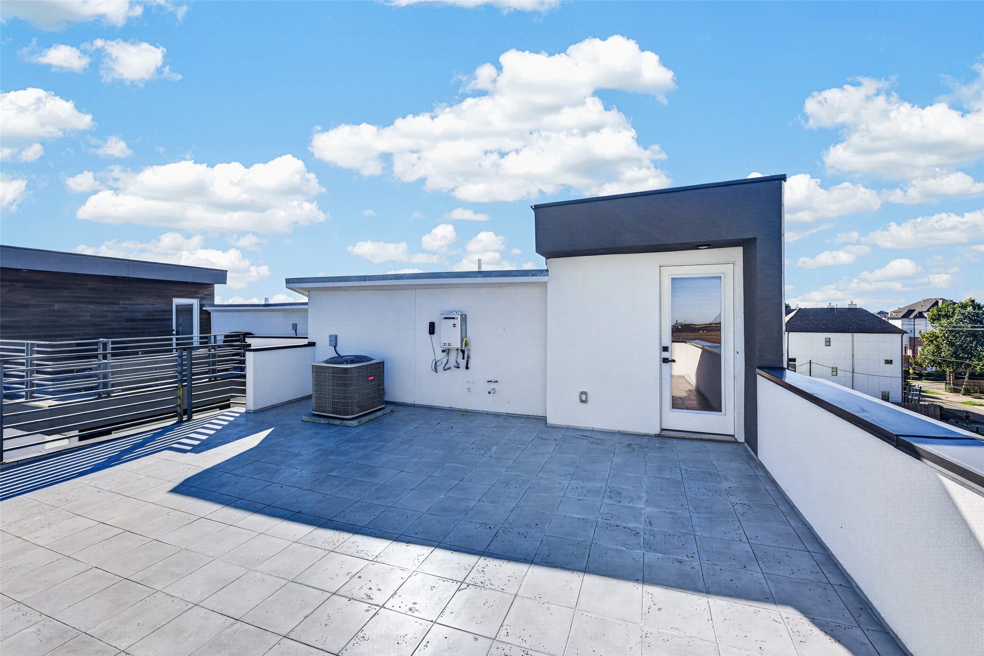 Spacious rooftop terrace offering paved tile flooring and panoramic views, perfect for outdoor entertaining.
