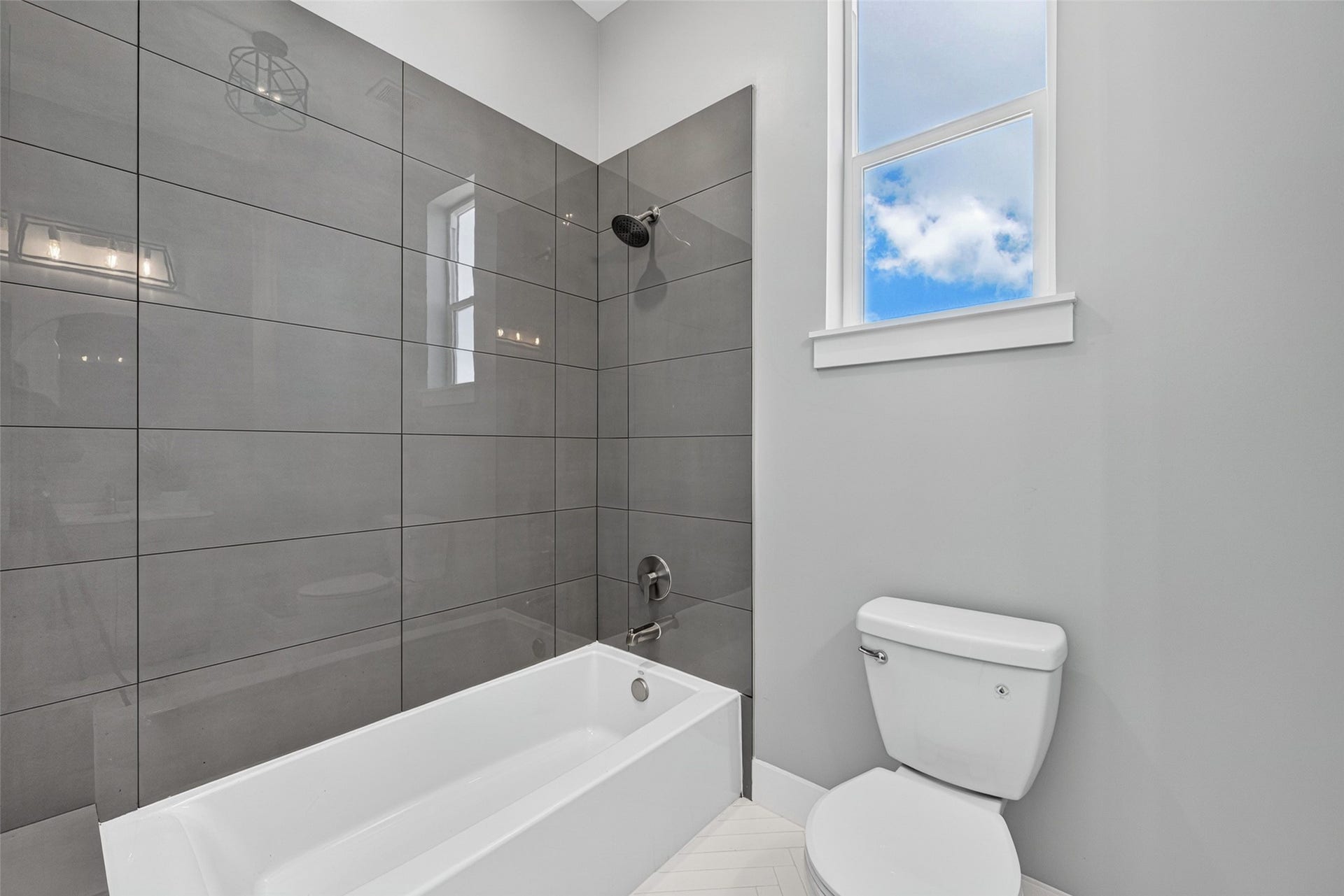 Third-floor full bathroom serving the secondary bedroom with clean, modern finishes.