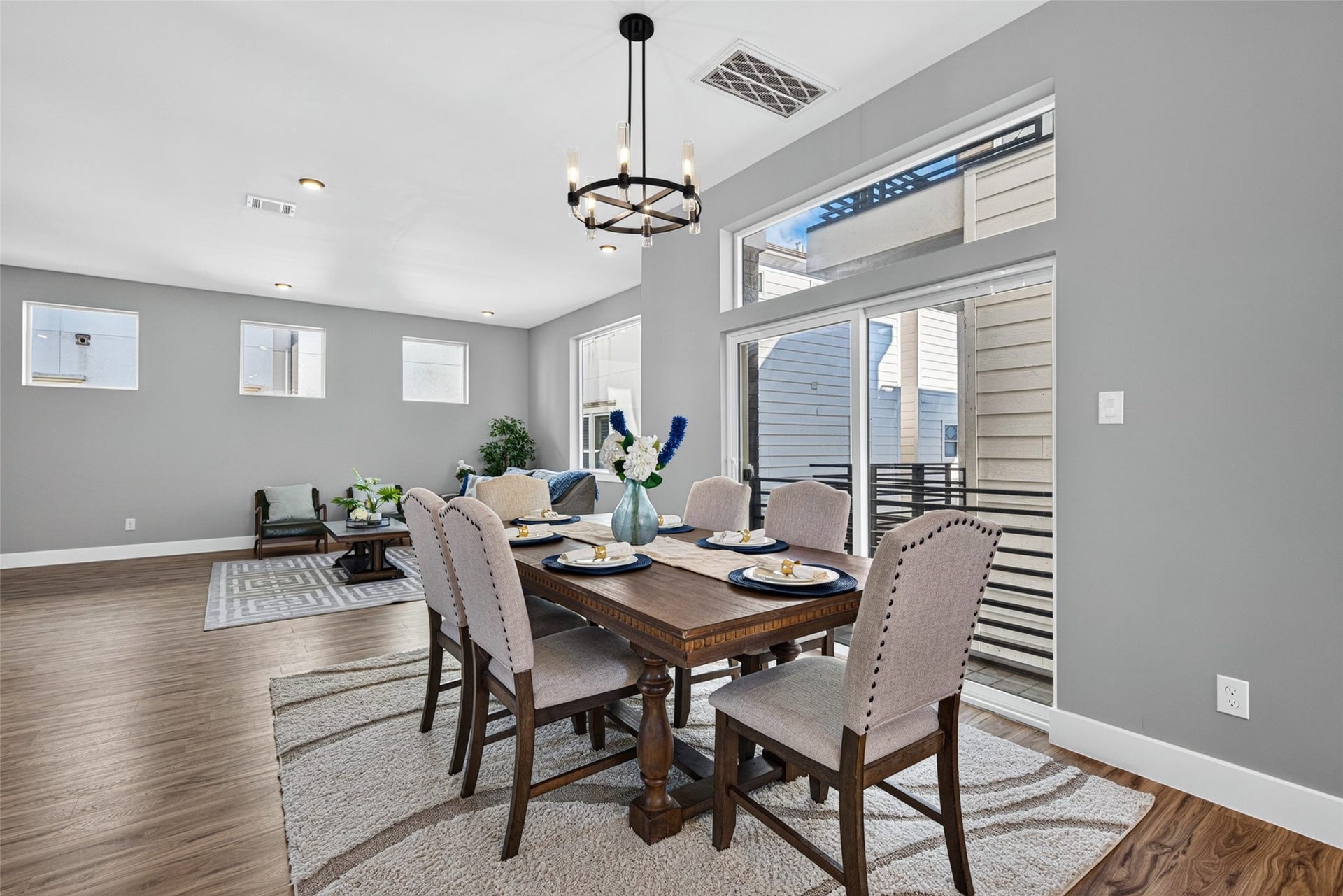 Sunlight fills the space through expansive windows, highlighting the beauty of the surrounding open-concept design.
