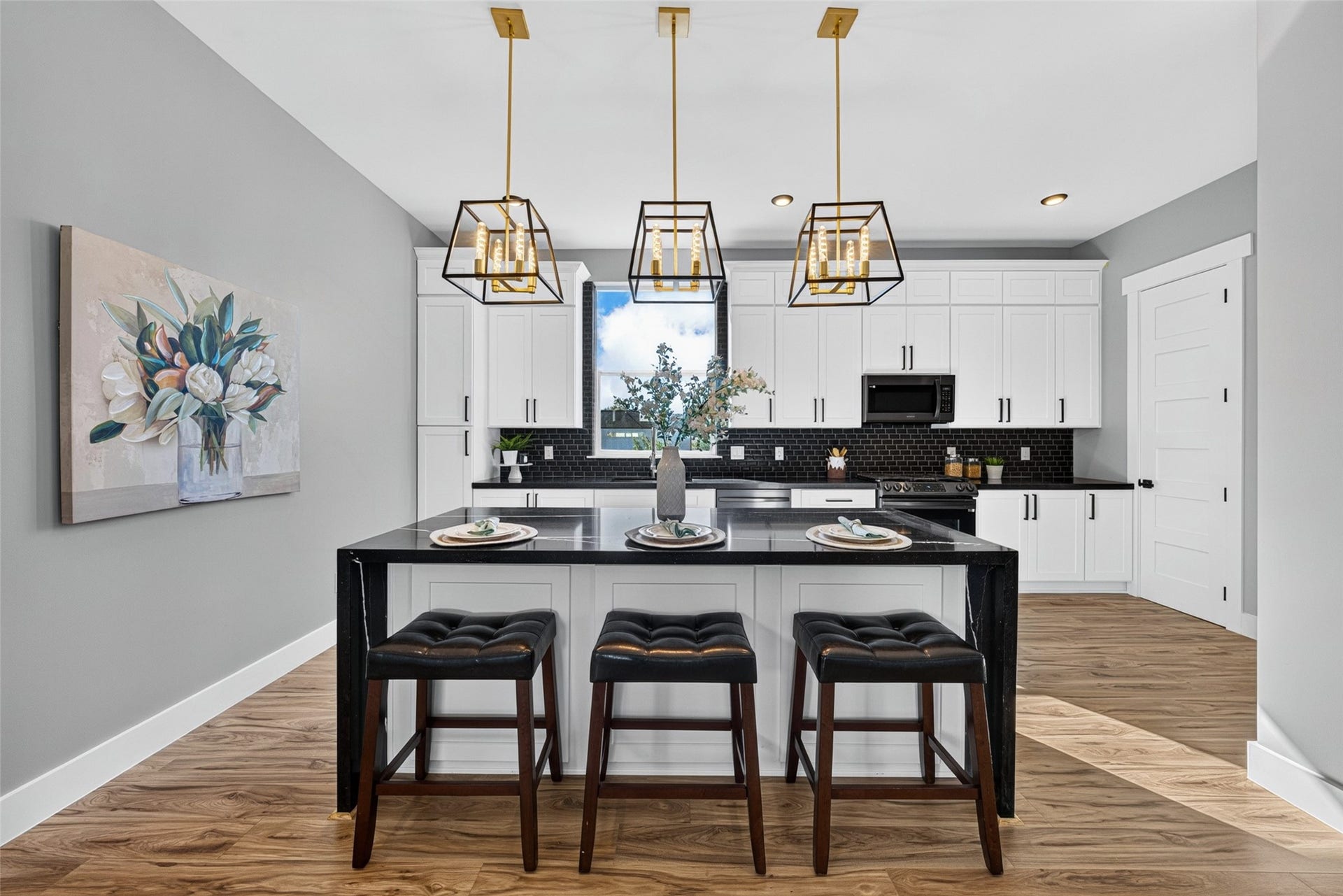The expansive kitchen island features a cozy breakfast bar, making it ideal for casual morning meals or chatting while preparing dinner.