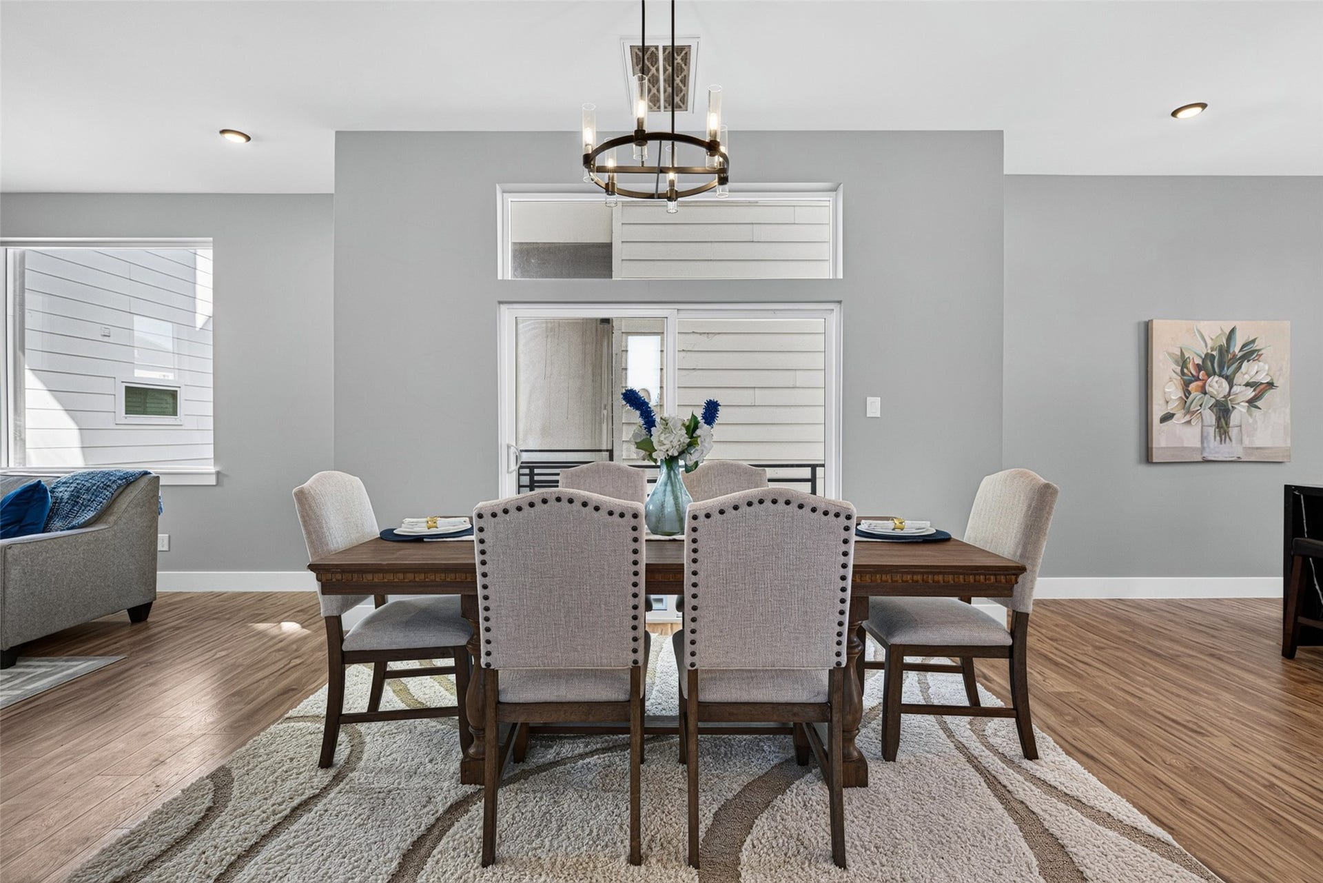 Broad glass doors open directly onto a private balcony, making it effortless to transition from indoor family meals to alfresco dining.