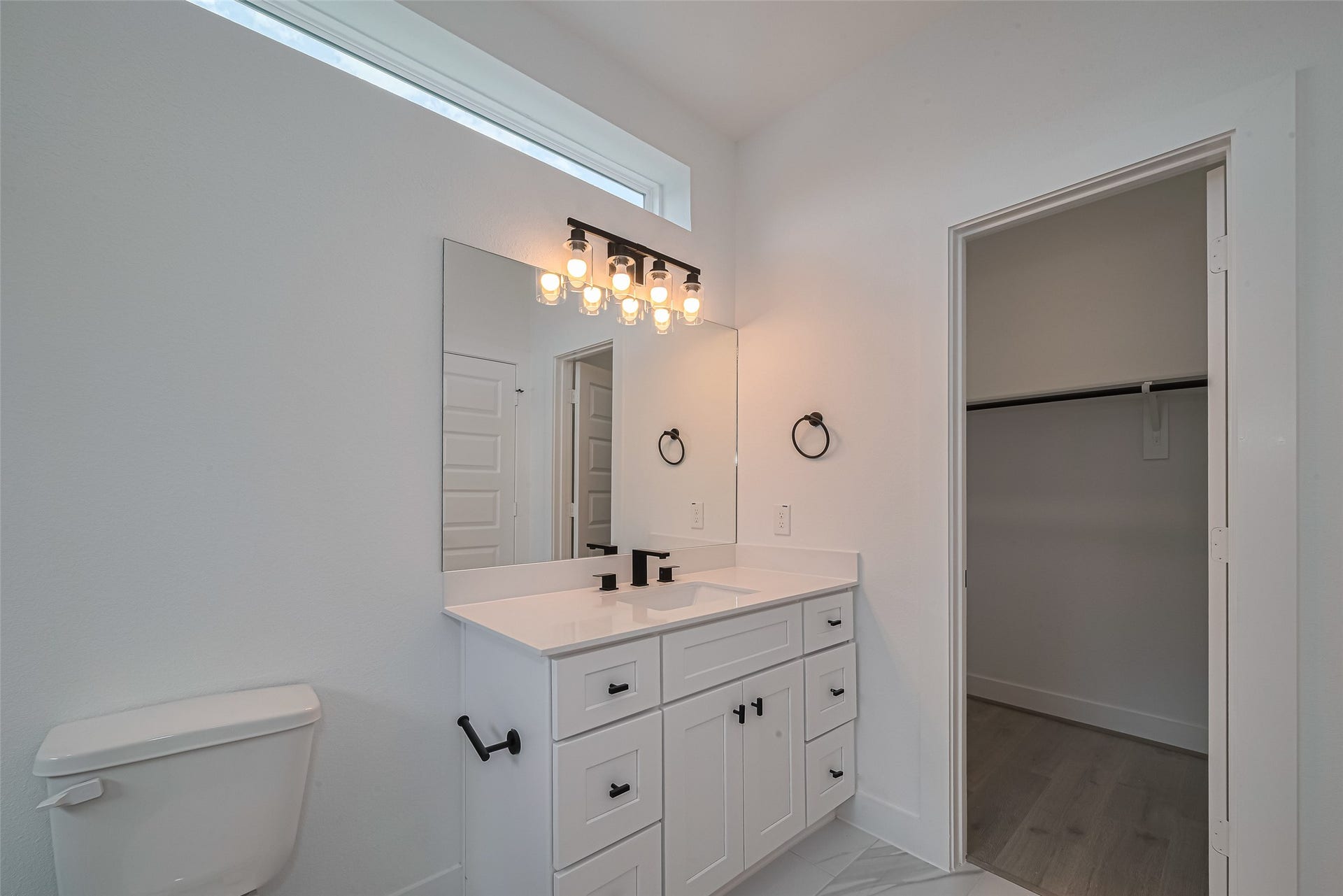 1354 W 24th Street, Houston, TX 77008 Bathroom vanity with stylish lighting and a clean, modern design.