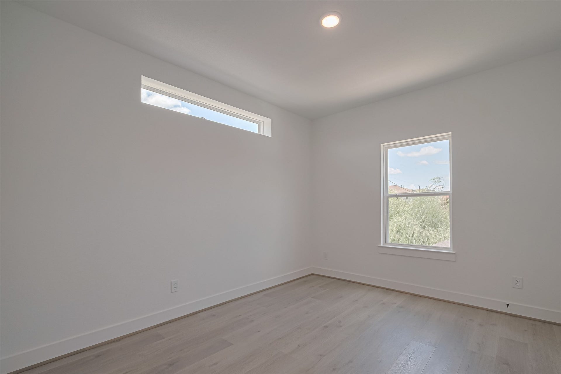 1354 W 24th Street, Houston, TX 77008 Bedroom with two windows bringing in natural light.