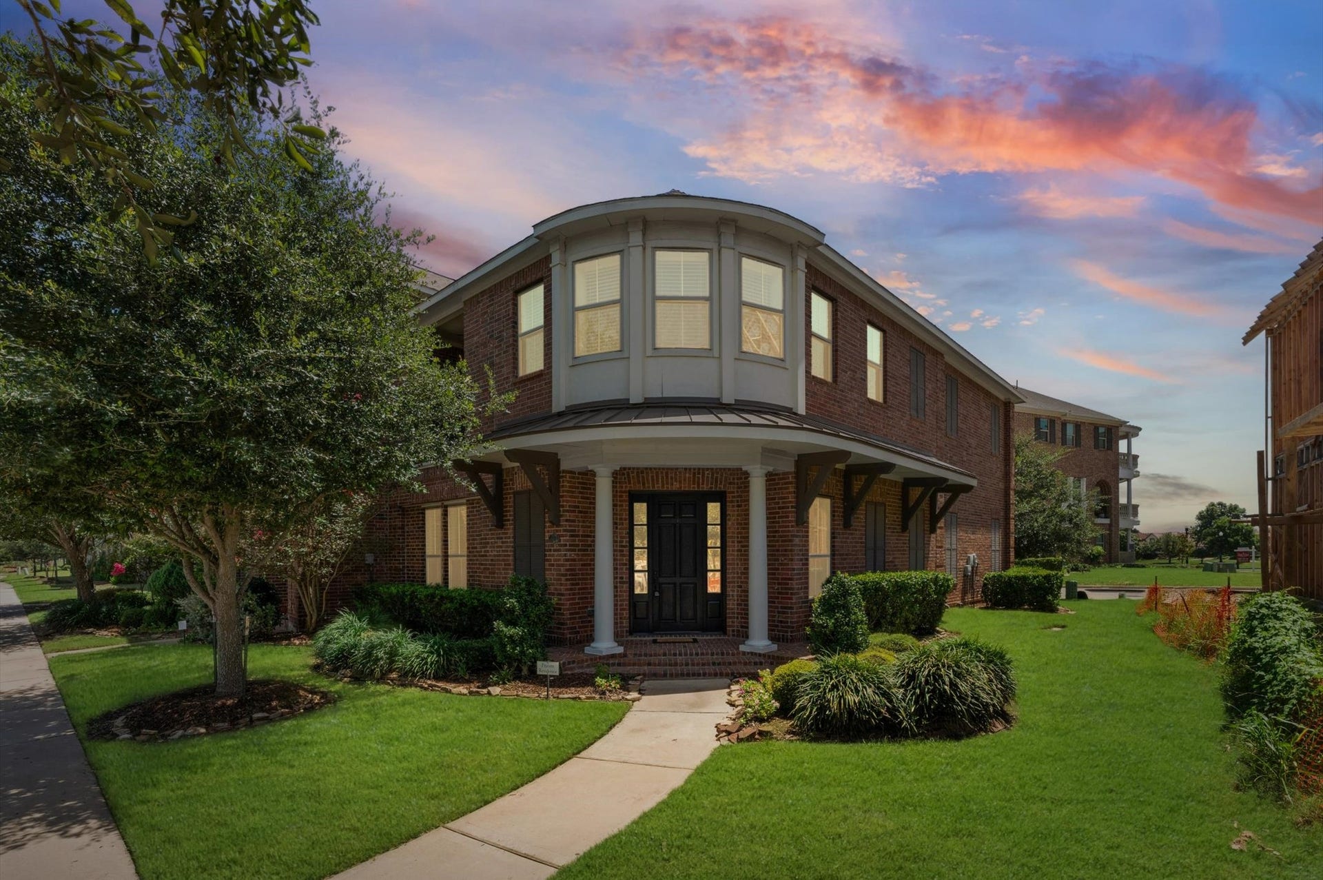 118 Stadium Drive, Sugar Land, TX 77498 Charming two-story brick home with a distinctive bay window and surrounded by beautiful landscaping.