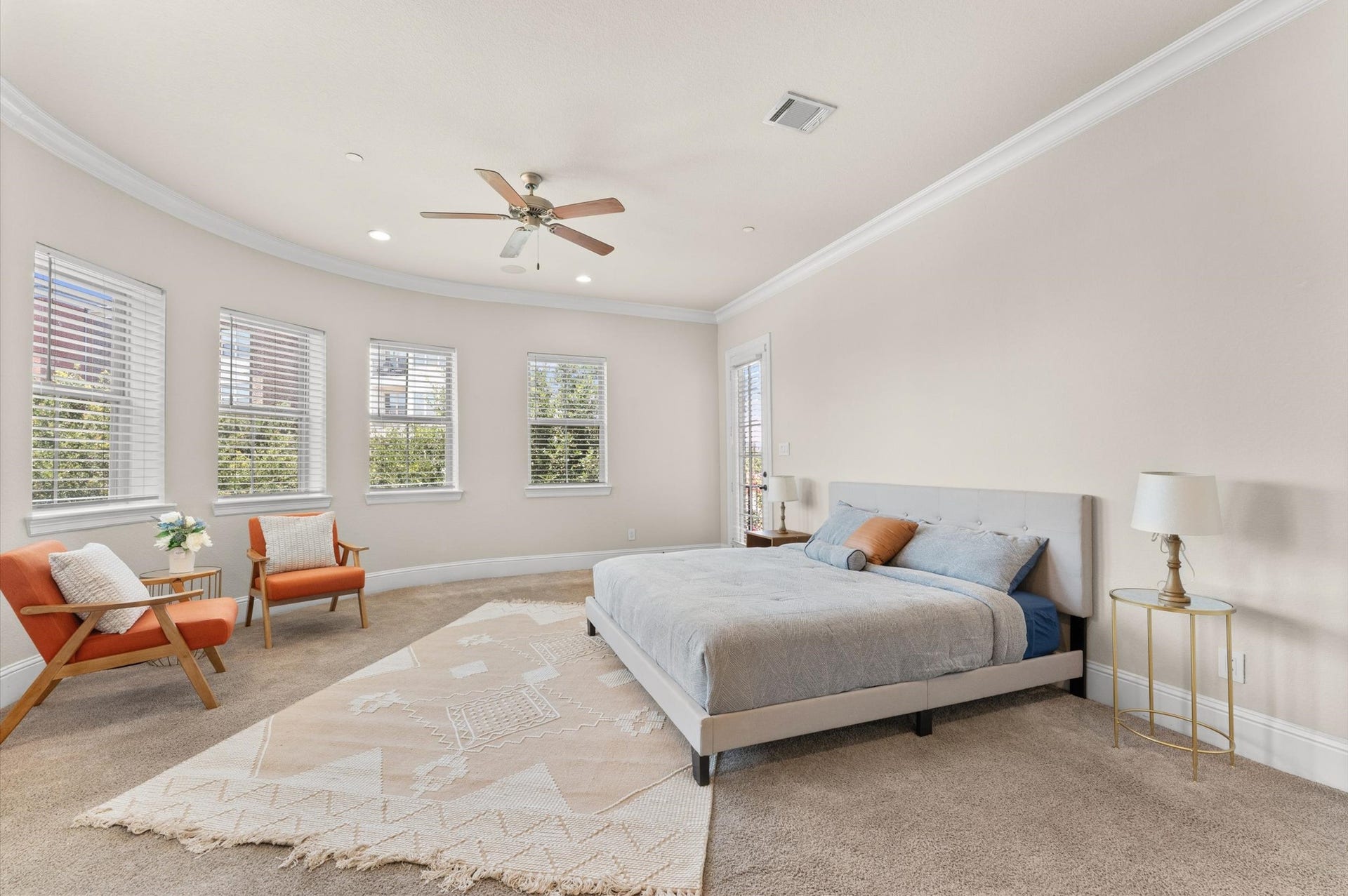 118 Stadium Drive, Sugar Land, TX 77498 Experience serene luxury in this spacious primary bedroom, featuring abundant natural light, a cozy seating area, and elegant design elements for ultimate relaxation.