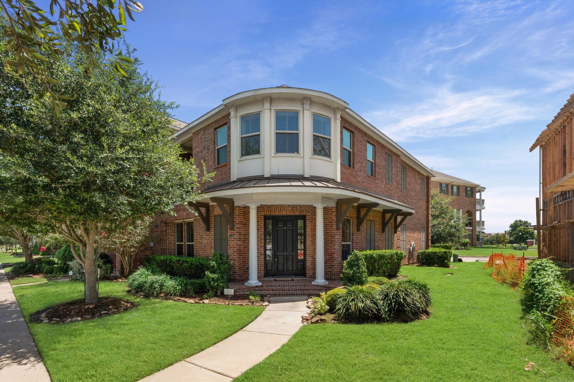 118 Stadium Drive, Sugar Land, TX 77498 Charming brick brownstone with a welcoming front porch and manicured Land.