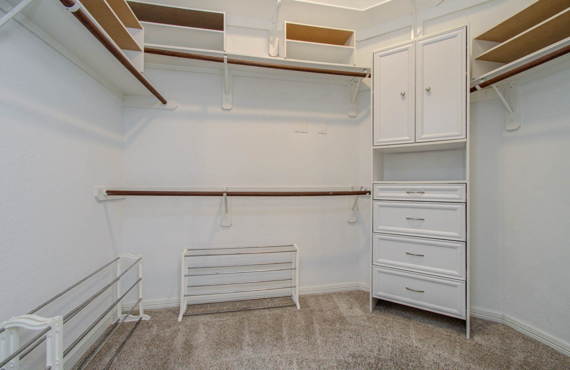 14403 Red Tailed Hawk Lane, Houston, TX 77044 Spacious walk-in closet featuring ample shelving, hanging space, and a built-in drawer unit for organized storage.